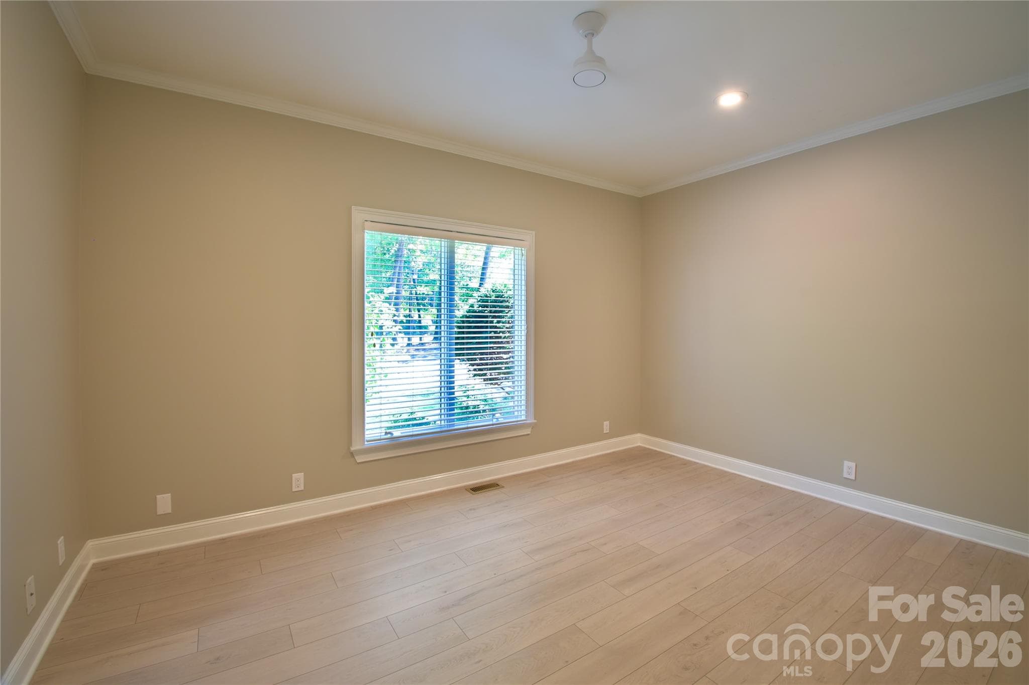 BR 1 on main floor with fresh new LVP flooring, paint, and ceiling fan. - 140 Holt Lane, Mooresville