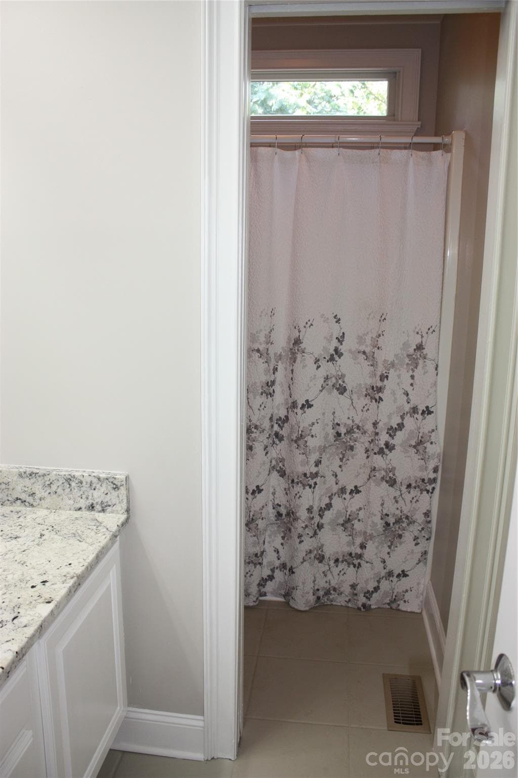 Center tiled hall bath with pocket door between sink and toilet/shower/tub. - 140 Holt Lane, Mooresville