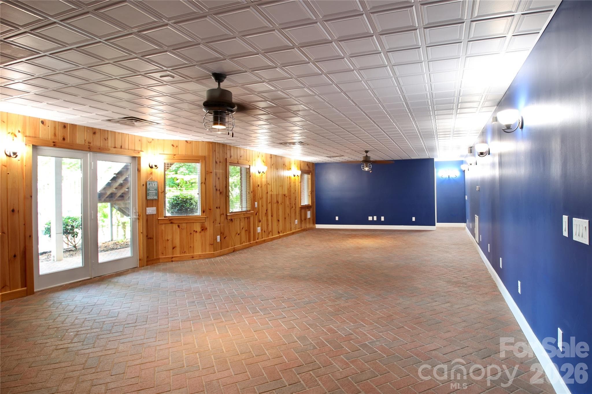 Walk-out basement featuring brick paver flooring has been used as a familyroom/billiard/recreation room. Huge space for whatever your heart desires! - 140 Holt Lane, Mooresville
