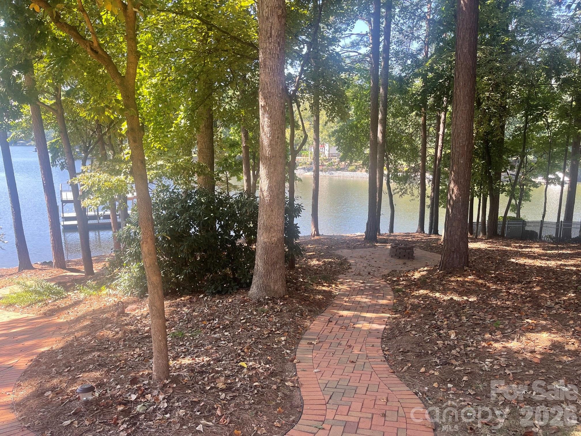 Brick paver sidewalks from the front to the back and to your quaint firepit. - 140 Holt Lane, Mooresville