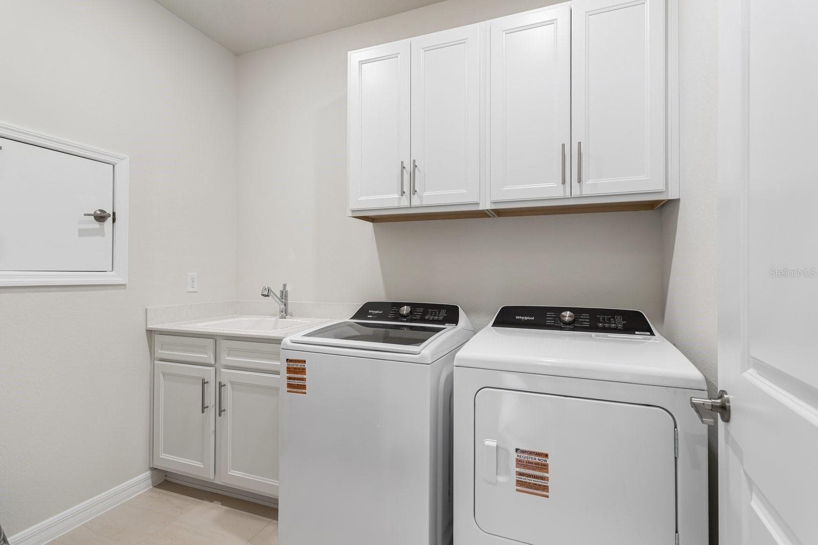 Laundry Room with sink and Cabinetry - 1323 ORANGE VALLEY RD, MINNEOLA