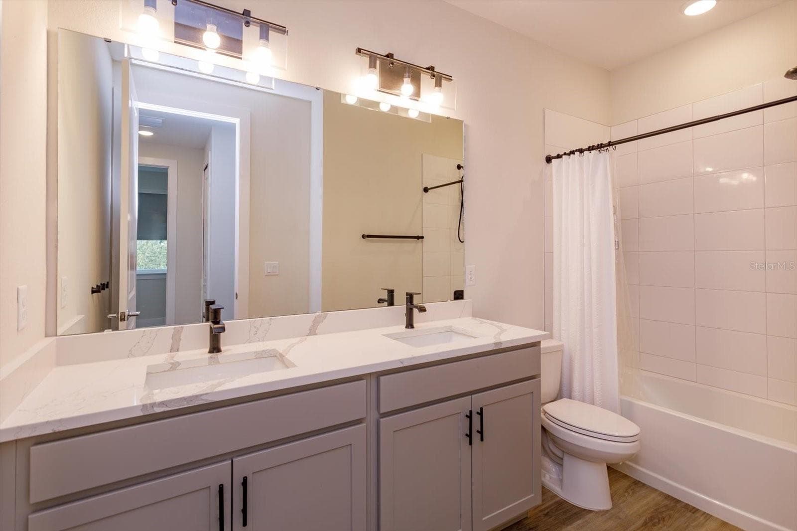 Second floor guest bathroom with dual sinks and quartz counters - 1430 BROOKDALE CT, OVIEDO