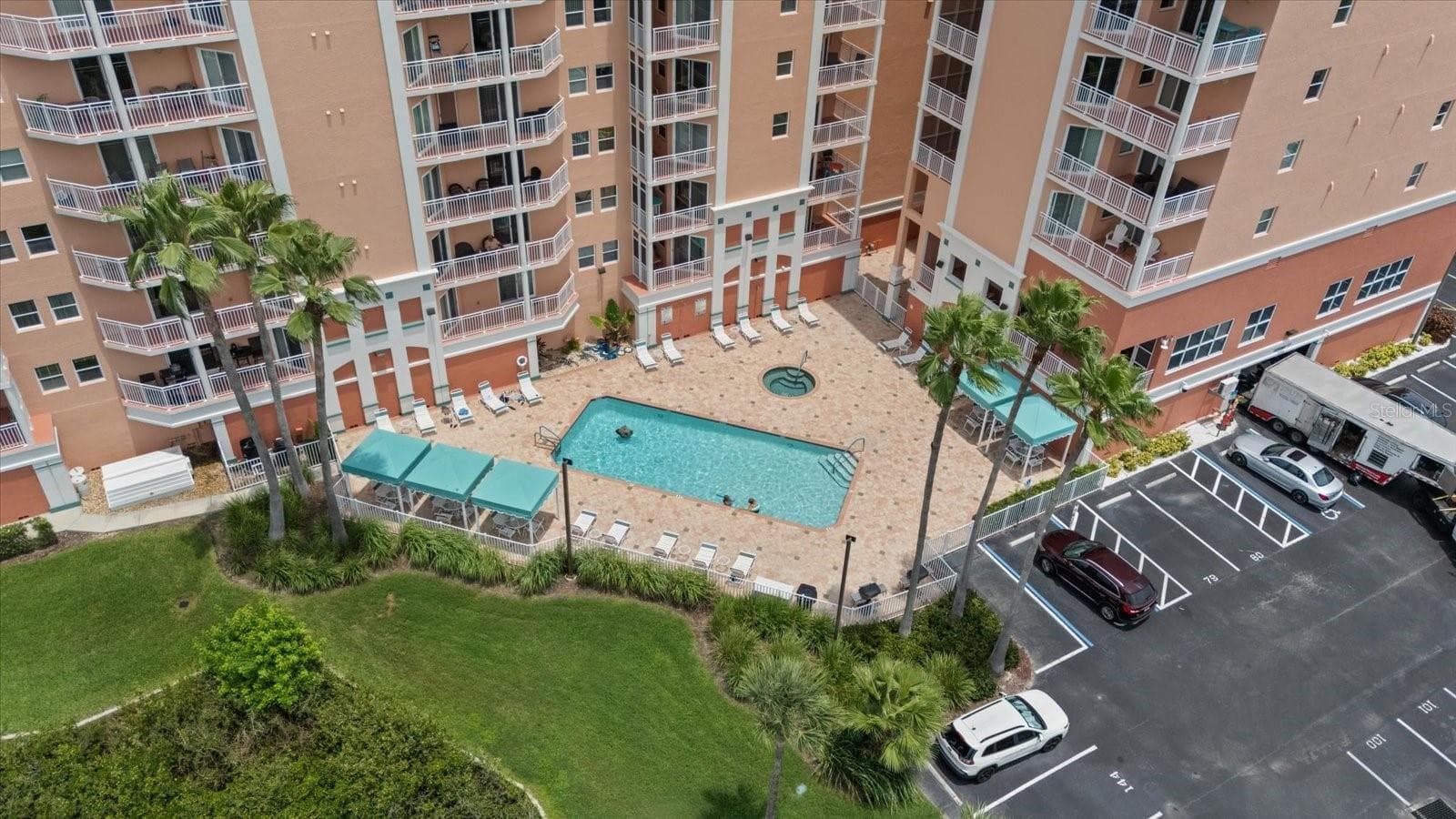 Community pool aerial view and back parking lot - 4516 SEAGULL DR #507, NEW PORT RICHEY
