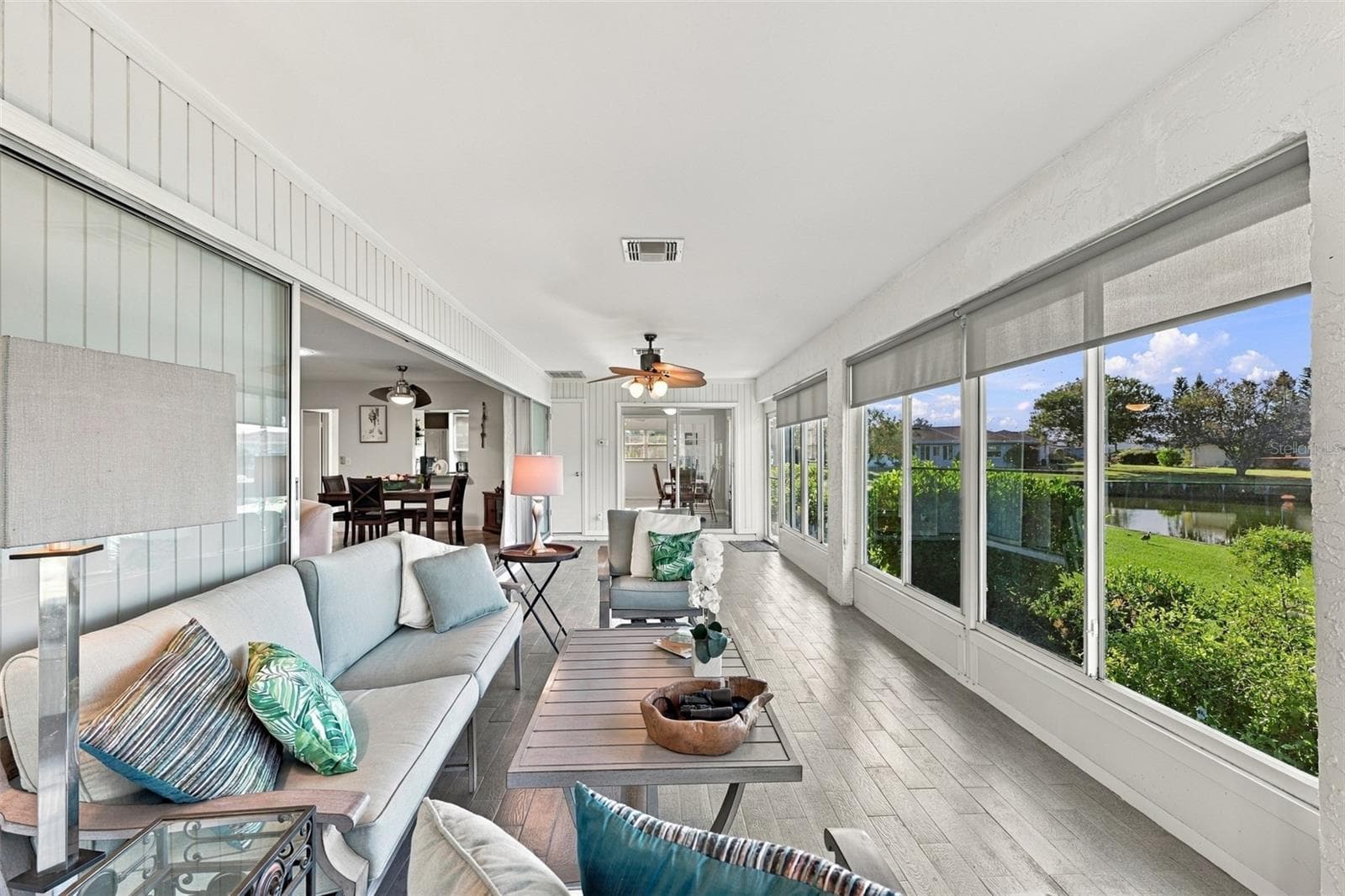 The perfect place to watch the world go by, read a book or just take a nap! Notice how the sliding glass doors all go behind the wall for maximum opening space. - 211 STONEHAM DR, SUN CITY CENTER