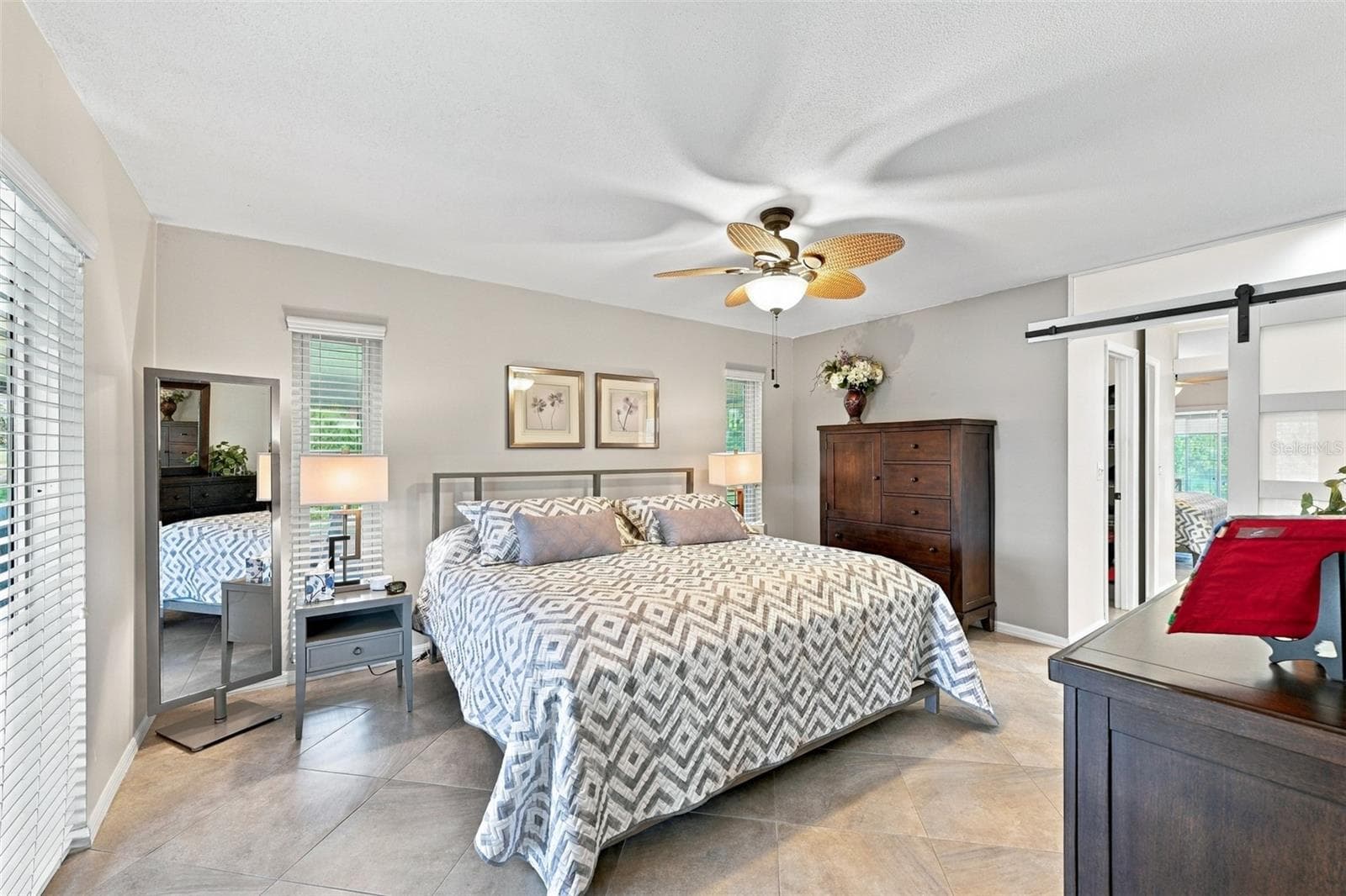 The primary bedroom has an ensuite bathroom for maximum privacy and a walk-in closet. - 211 STONEHAM DR, SUN CITY CENTER