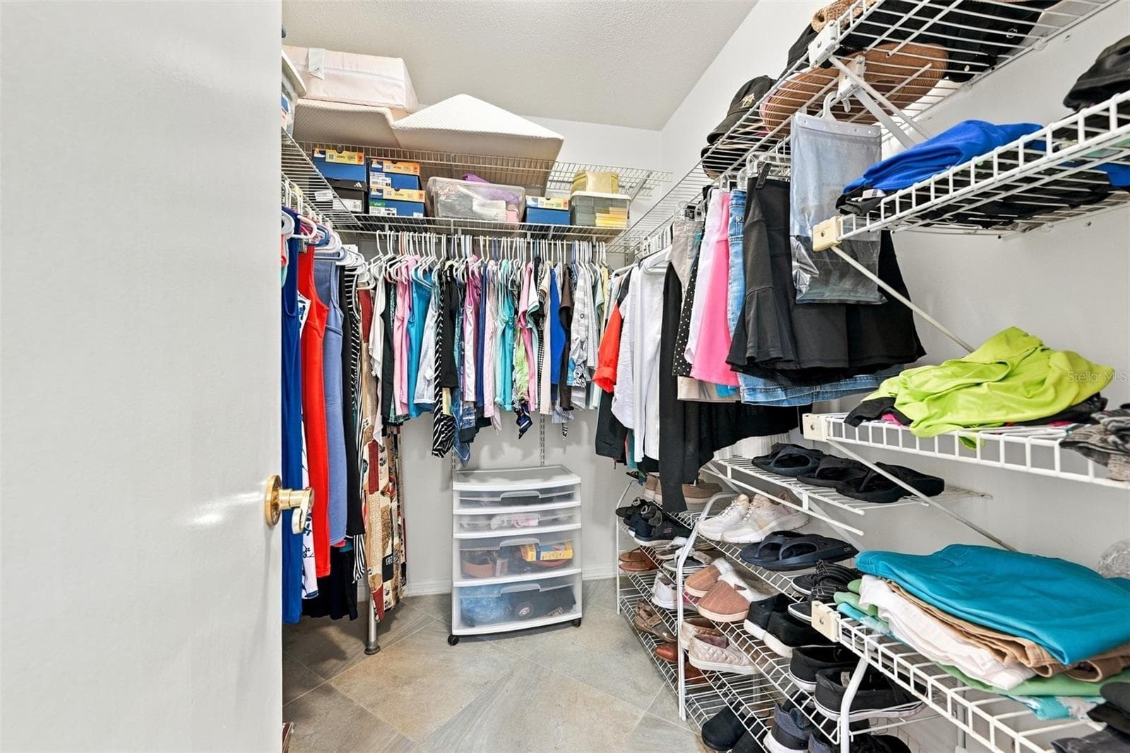 Large walk-in closet with lots of shelving for storage. - 211 STONEHAM DR, SUN CITY CENTER