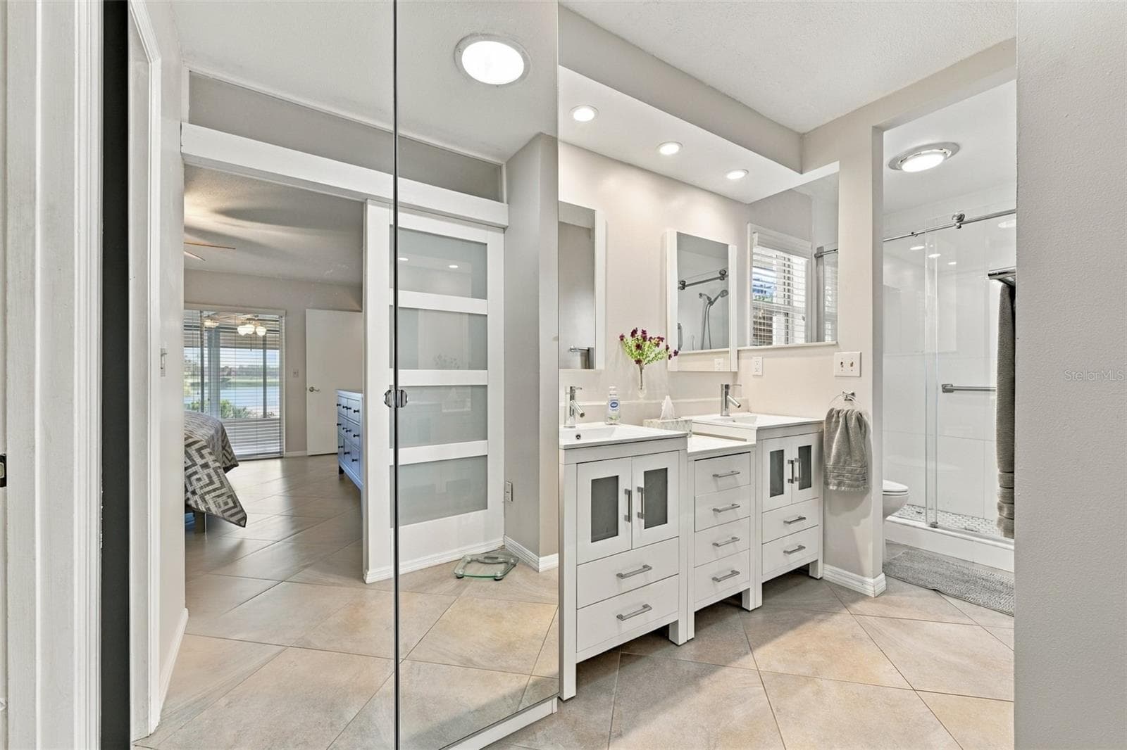 Stunning ensuite bathroom with dual sinks, updated shower and modern fistures. - 211 STONEHAM DR, SUN CITY CENTER