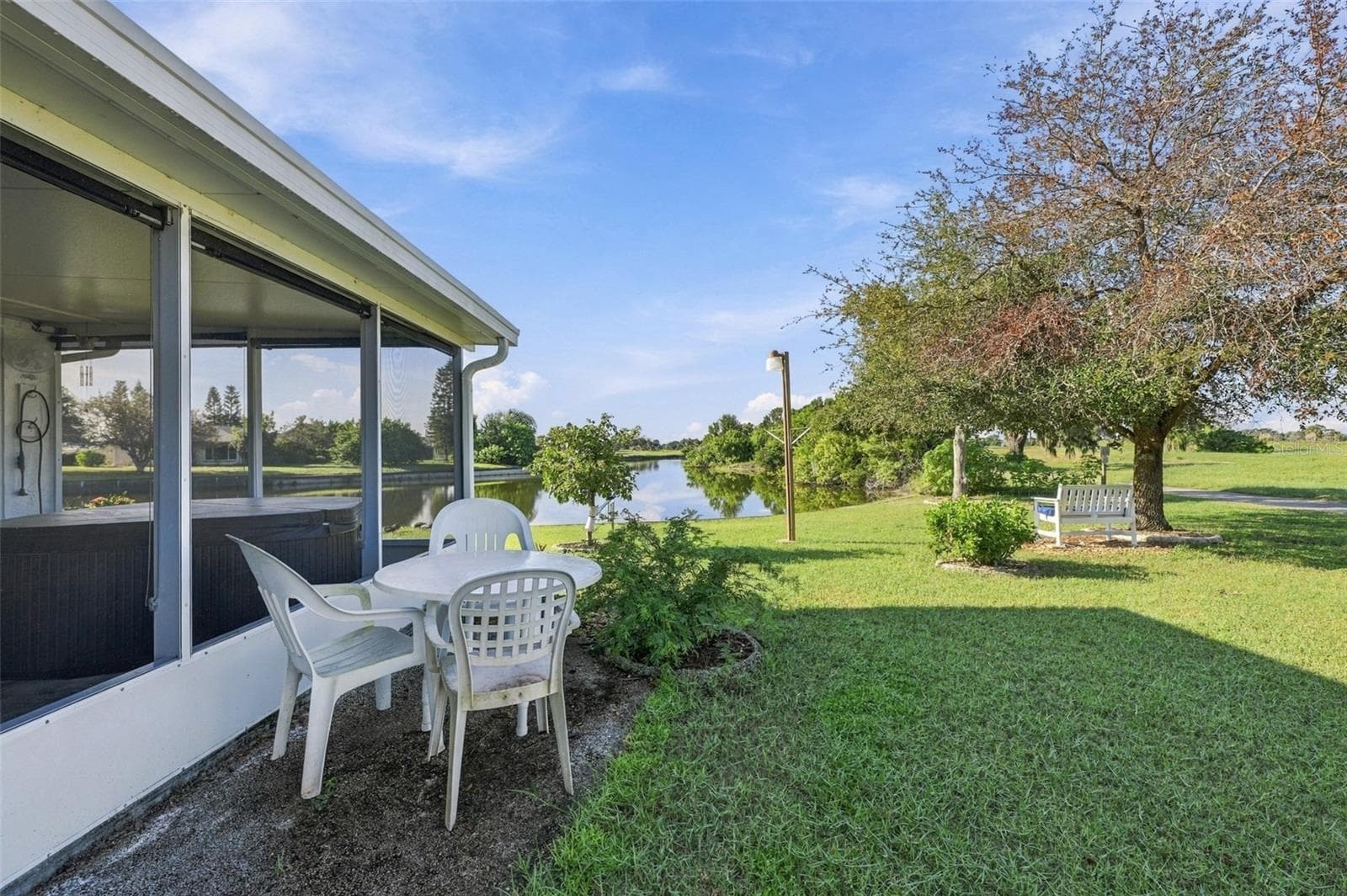 The green space is incredible with an outside bench and light to enjoy this premium lot. - 211 STONEHAM DR, SUN CITY CENTER