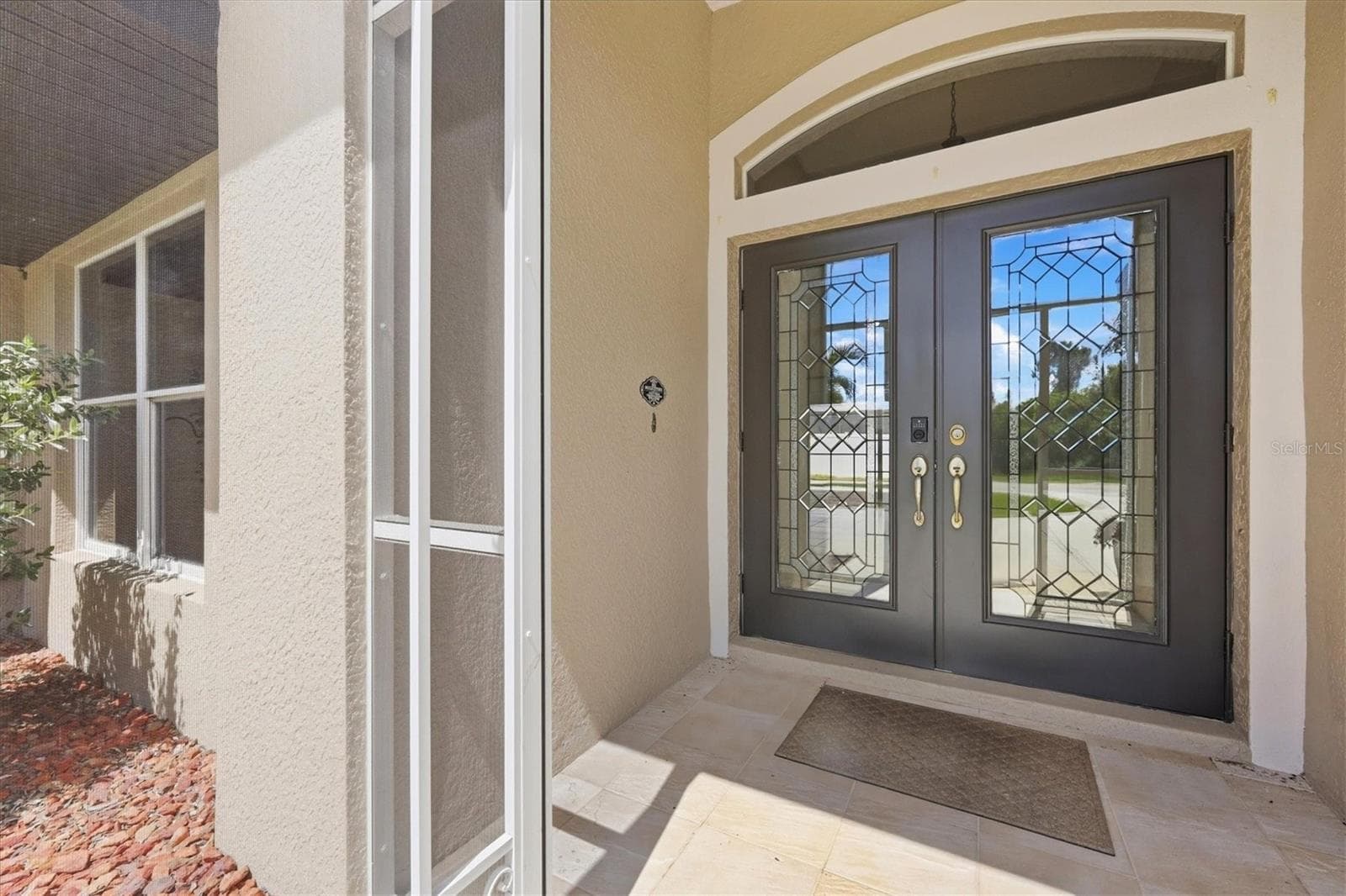 Gorgeous double front entry doors with tiled and screened entrance - 23108 AUGUST AVE, PORT CHARLOTTE