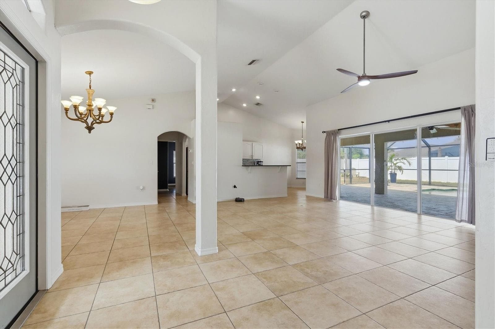 view from entry showing the open floorplan,living room right, dining left kitchen and breakast nook far rear - 23108 AUGUST AVE, PORT CHARLOTTE