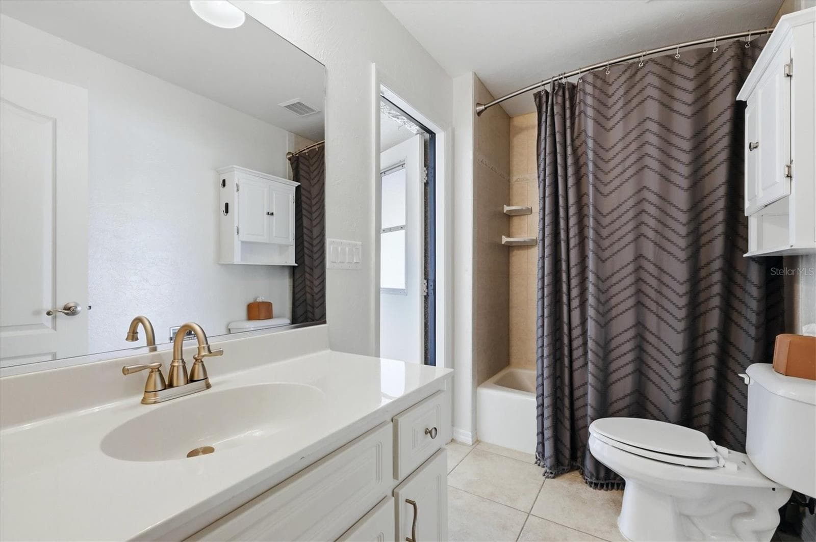 guest bath doubles as pool bath with direct exit to pool area - 23108 AUGUST AVE, PORT CHARLOTTE