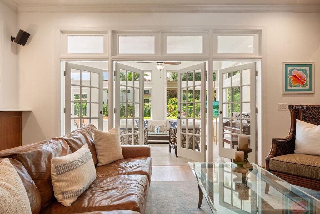 Family room leading to light and bright sunporch. - 555 E LAKE SUE AVE, WINTER PARK
