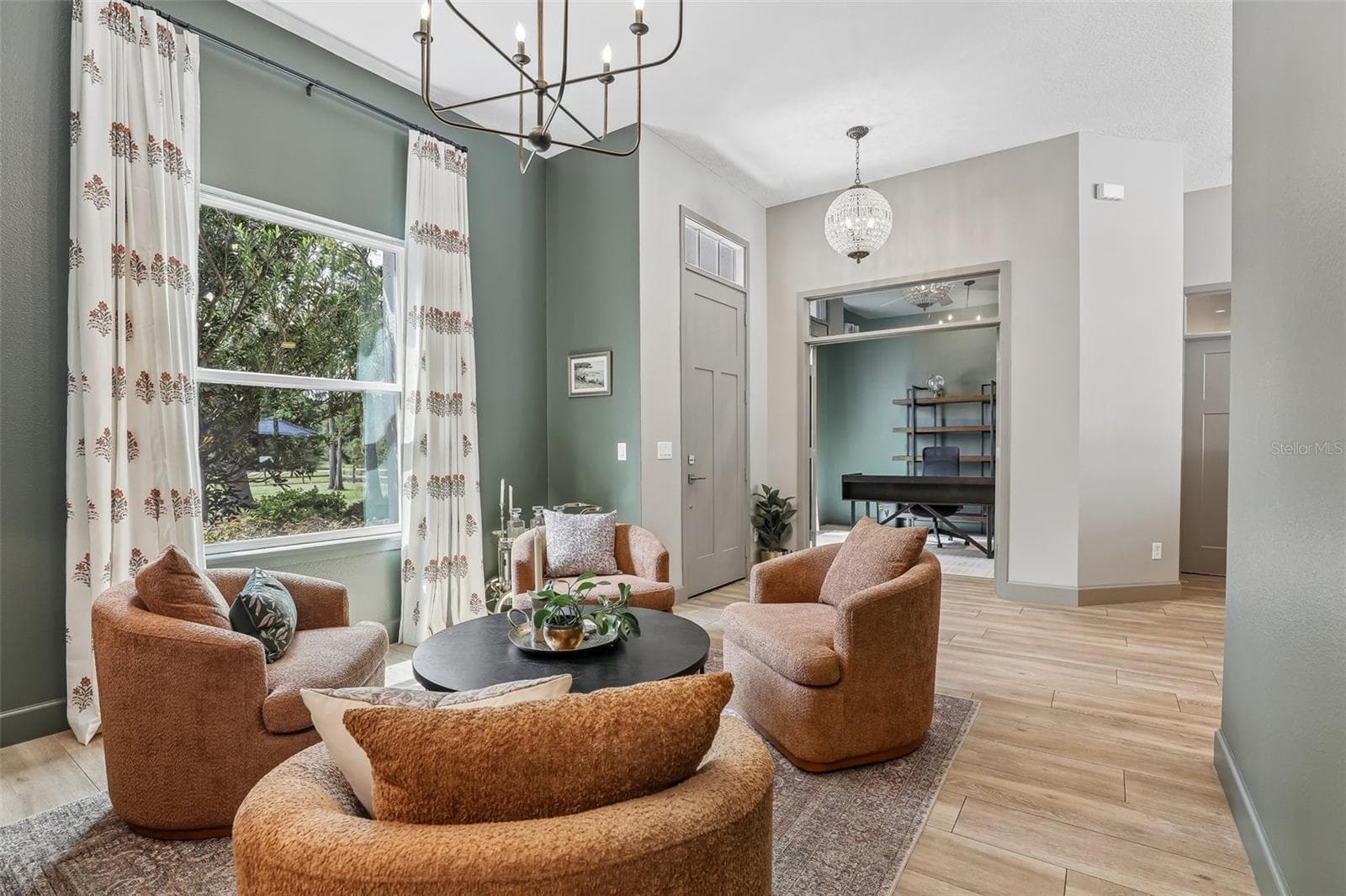 The Formal Living Room offers a peaceful view of the front yard and features a stylish ACCENT WALL. - 19179 SABAL ST, ORLANDO
