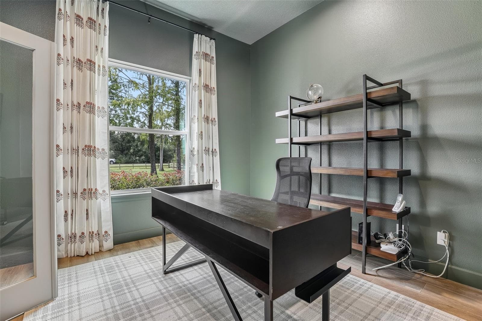 Glass French doors open to a versatile OFFICE OR FLEX SPACE. - 19179 SABAL ST, ORLANDO