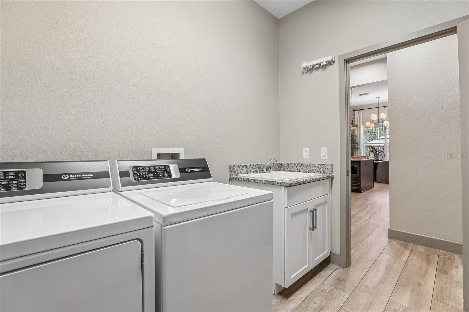 A nearby Laundry Room includes a VANITY WITH SINK for added convenience. - 19179 SABAL ST, ORLANDO