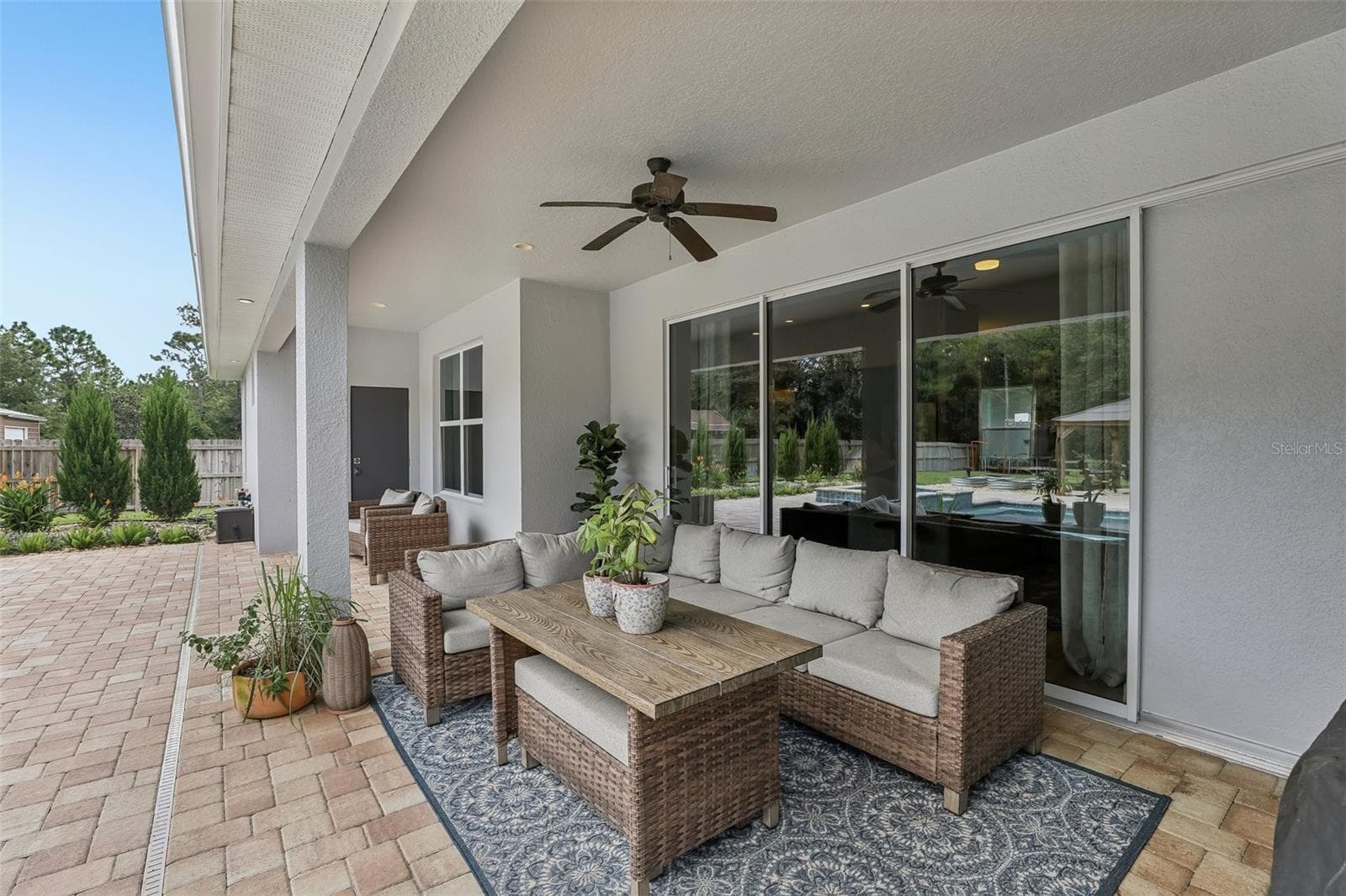 A COVERED PORCH AND EXTENDED PATIO with brick pavers provides plenty of space for outdoor dining, lounging and entertaining. - 19179 SABAL ST, ORLANDO