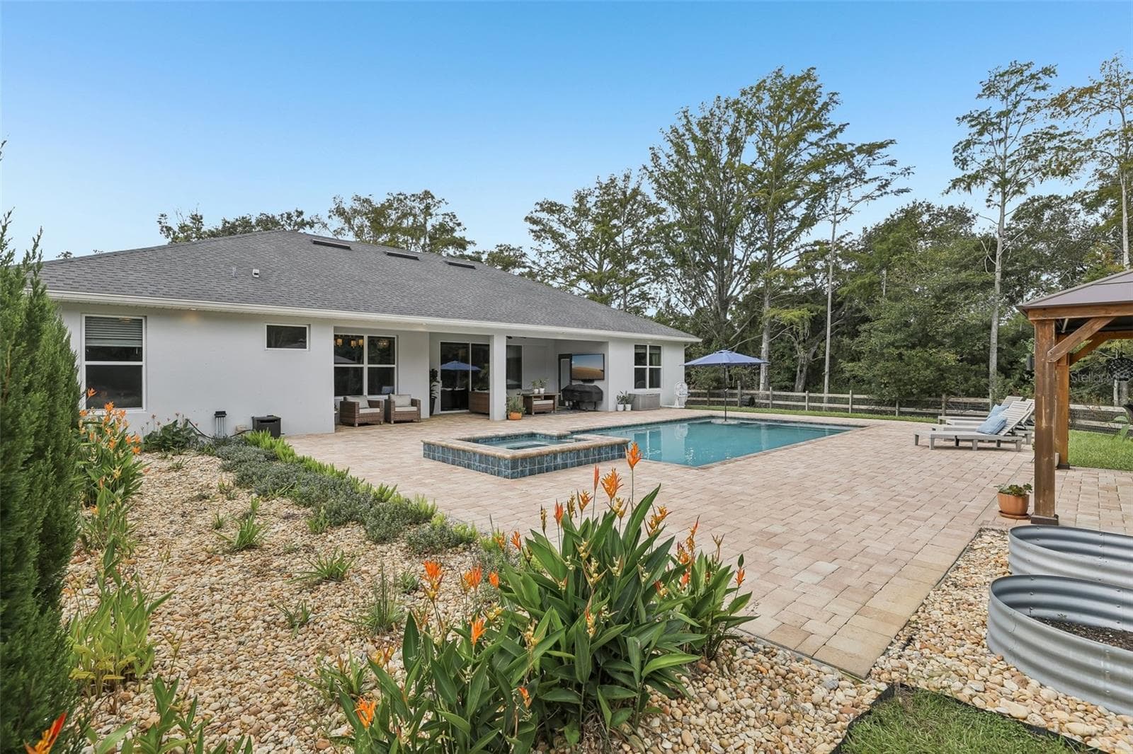 Step outside to your backyard retreat and enjoy the HEATED, SALT-WATER POOL AND SPA (2025). - 19179 SABAL ST, ORLANDO