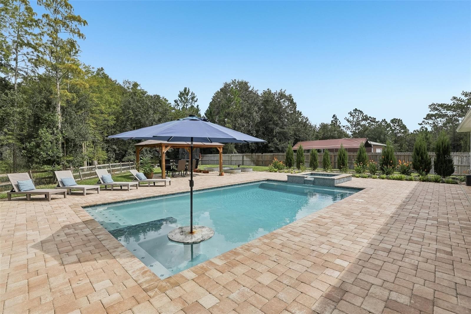 The home features a spectacular HEATED, SALT-WATER POOL WITH SPA, added in 2025. - 19179 SABAL ST, ORLANDO