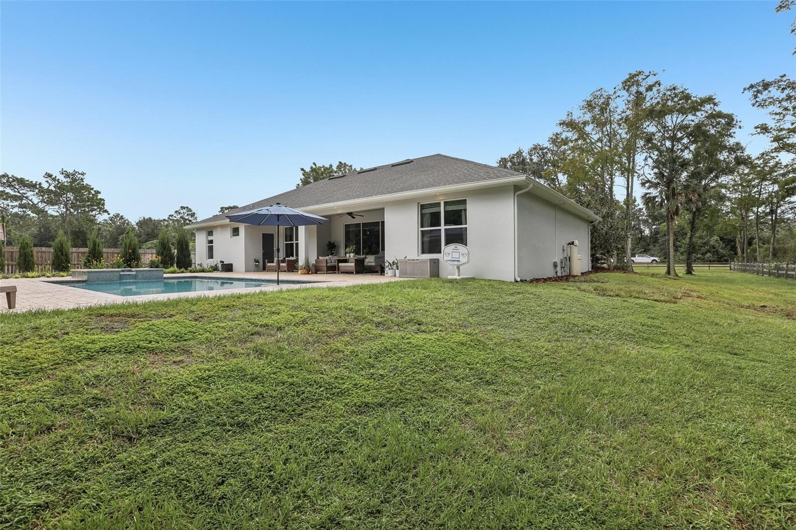 The EXPANSIVE FENCED BACKYARD offers room to garden, play or simply enjoy the peaceful surroundings. - 19179 SABAL ST, ORLANDO