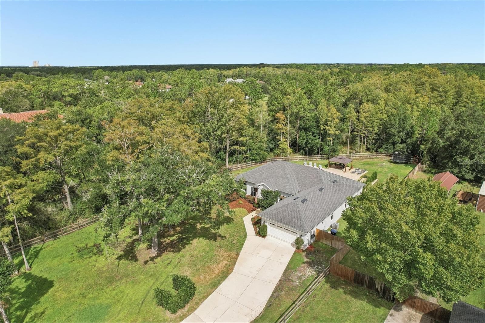 As you drive up the long driveway through an ELECTRIC-GATED ENTRANCE, beautiful landscaping with HAVEN LANDSCAPE UPLIGHTING welcomes you. - 19179 SABAL ST, ORLANDO