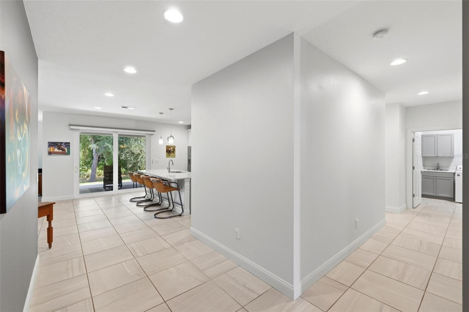 Wide hallways leading to kitchen/living and laundry then primary suite - 6172 ALHAMBRA AVE, NORTH PORT