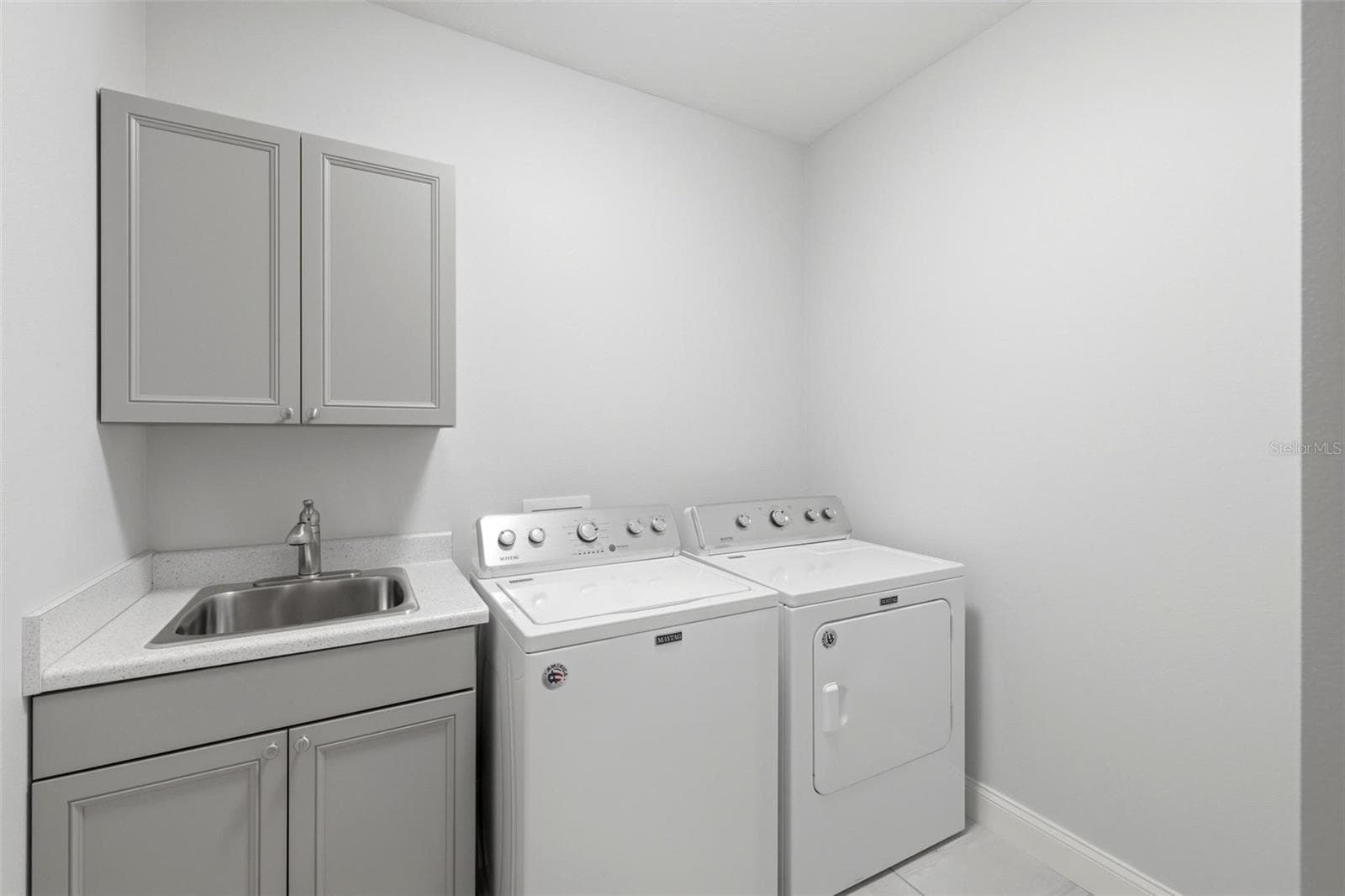 Spacious laundry room with cabinets and a utility closet - 6172 ALHAMBRA AVE, NORTH PORT