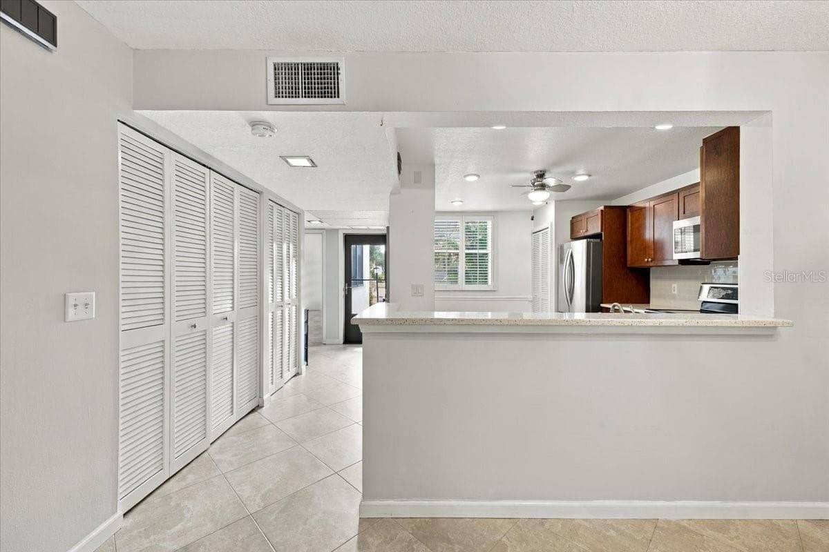 Hallway into unit with two closets - 411 PALM TREE DR #411, BRADENTON