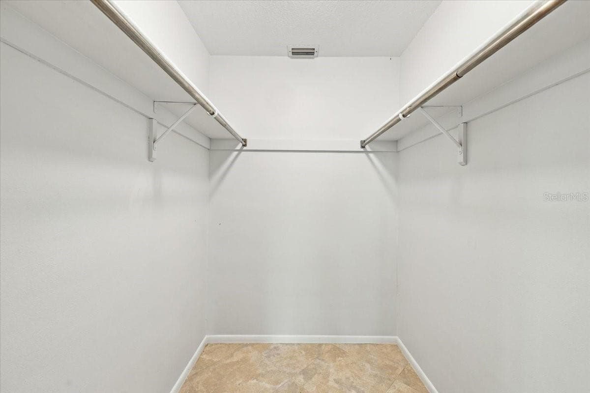 Walkin closet in primary bedroom - 411 PALM TREE DR #411, BRADENTON