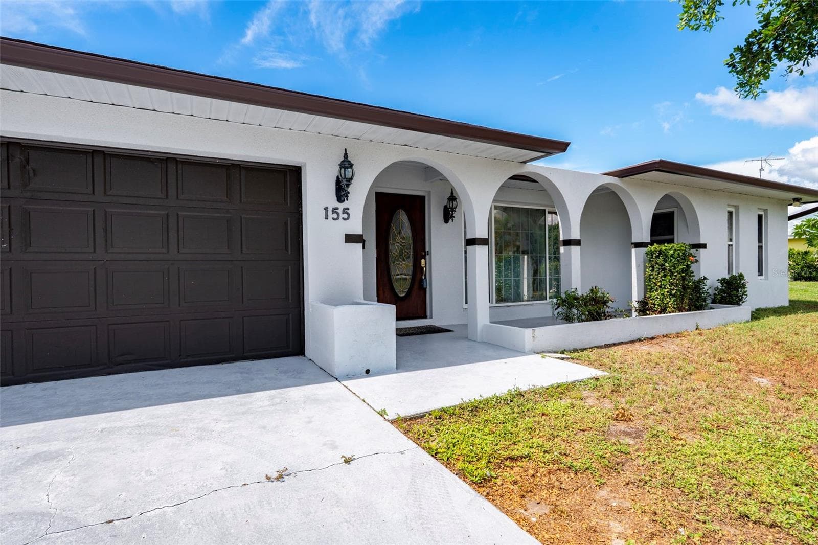 Welcoming Front Entrance with Charming Architectural Details - 155 MORGAN LN SE, PORT CHARLOTTE