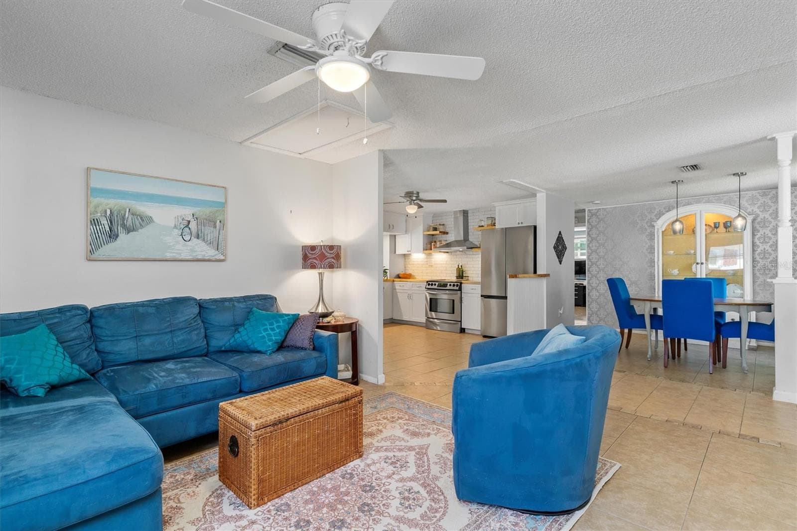 The open main living area provides generous space for gathering while connecting naturally with the dining area and kitchen. Photo taken during prior occupancy. - 142 2ND AVE, NOKOMIS
