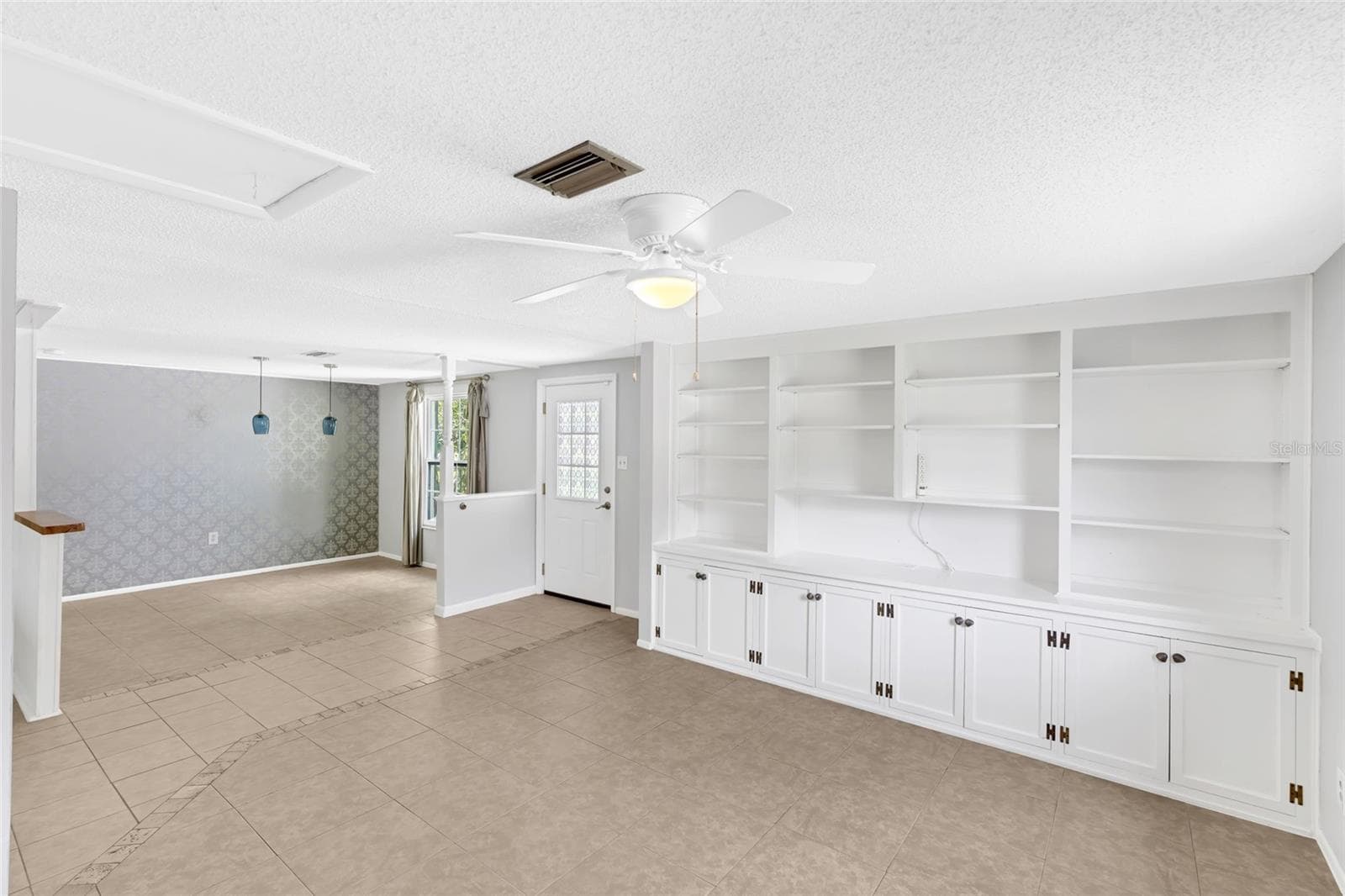 Built in shelving adds character and useful storage to the spacious front living area. - 142 2ND AVE, NOKOMIS