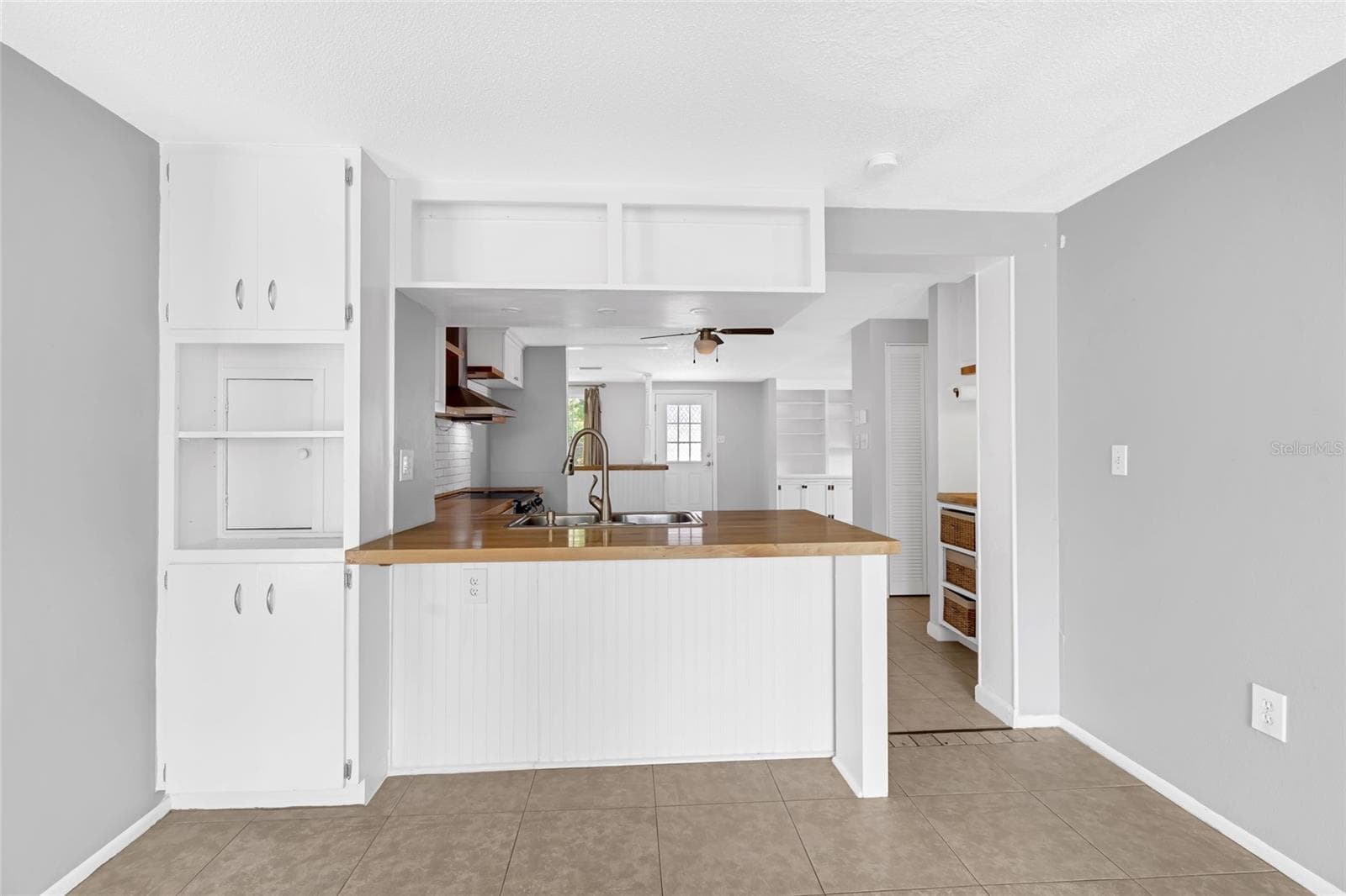 Breakfast bar adds casual seating and extra prep space while keeping the kitchen connected to the adjoining family room - 142 2ND AVE, NOKOMIS