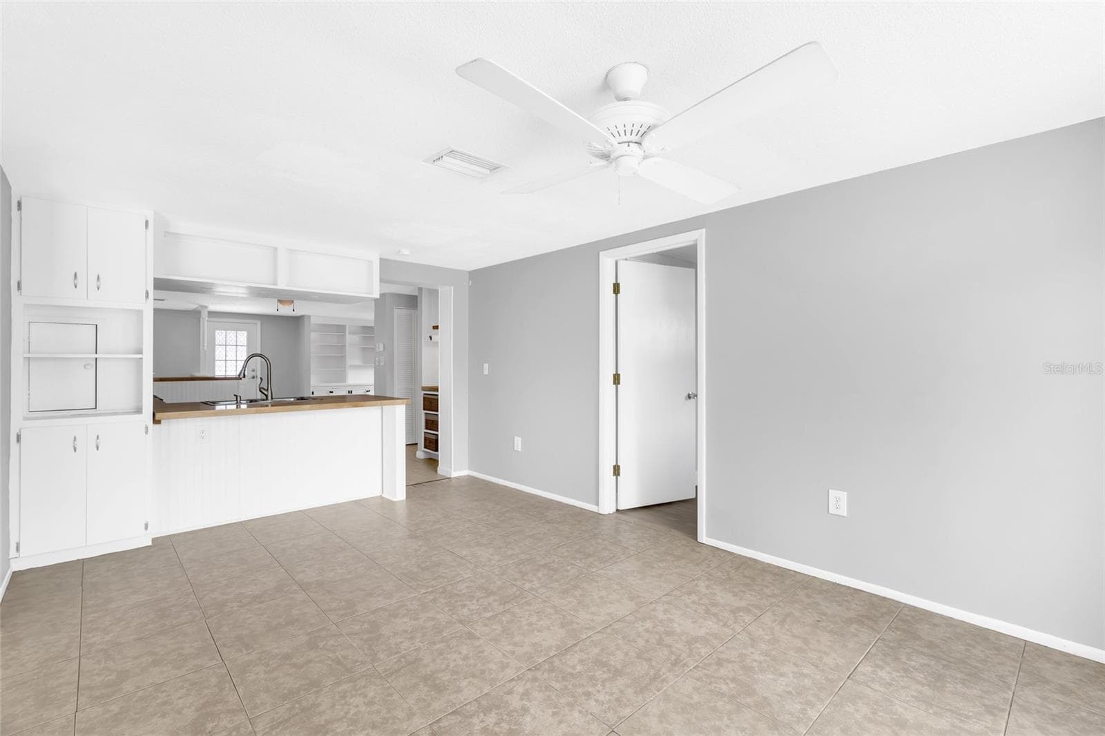 The kitchen opens directly to the family room, creating an easy everyday flow while keeping the spaces distinct. - 142 2ND AVE, NOKOMIS