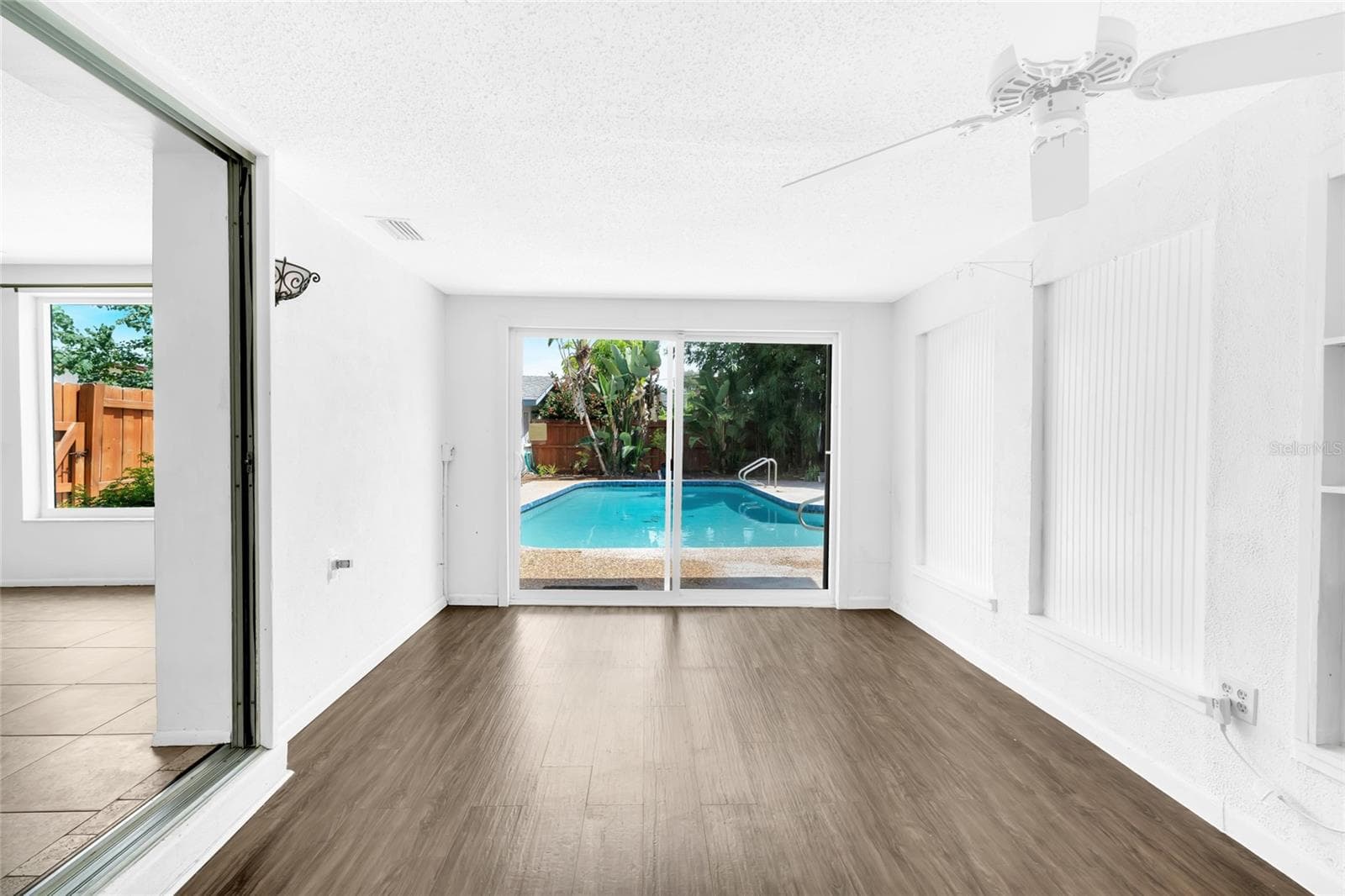 Flexible bonus room overlooking the backyard pool with direct access to the rear living area. - 142 2ND AVE, NOKOMIS