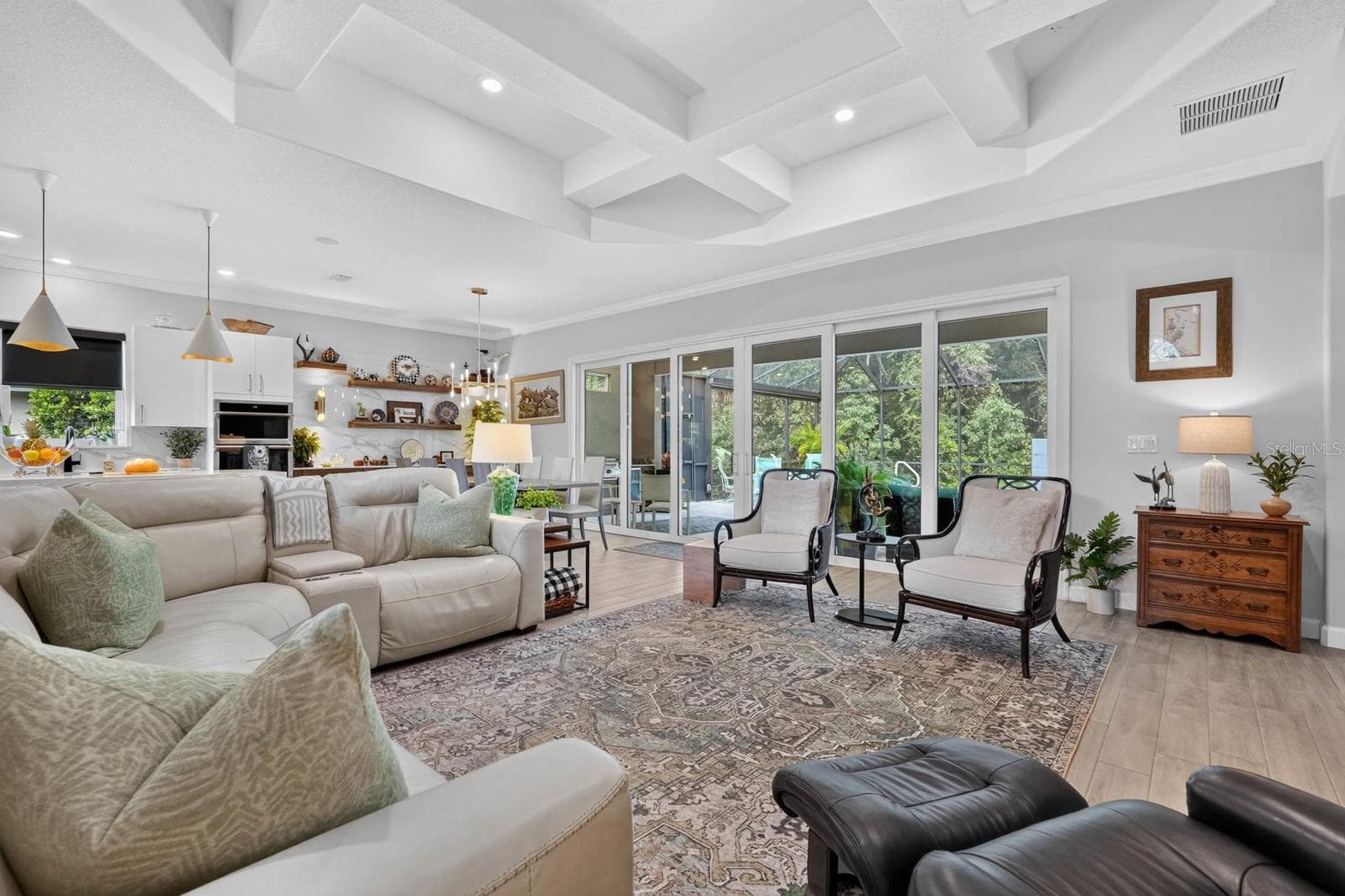 This large great room features a wall of sliders that open up into the private backyard space - 36 NEW WATER OAK DR, PALM COAST