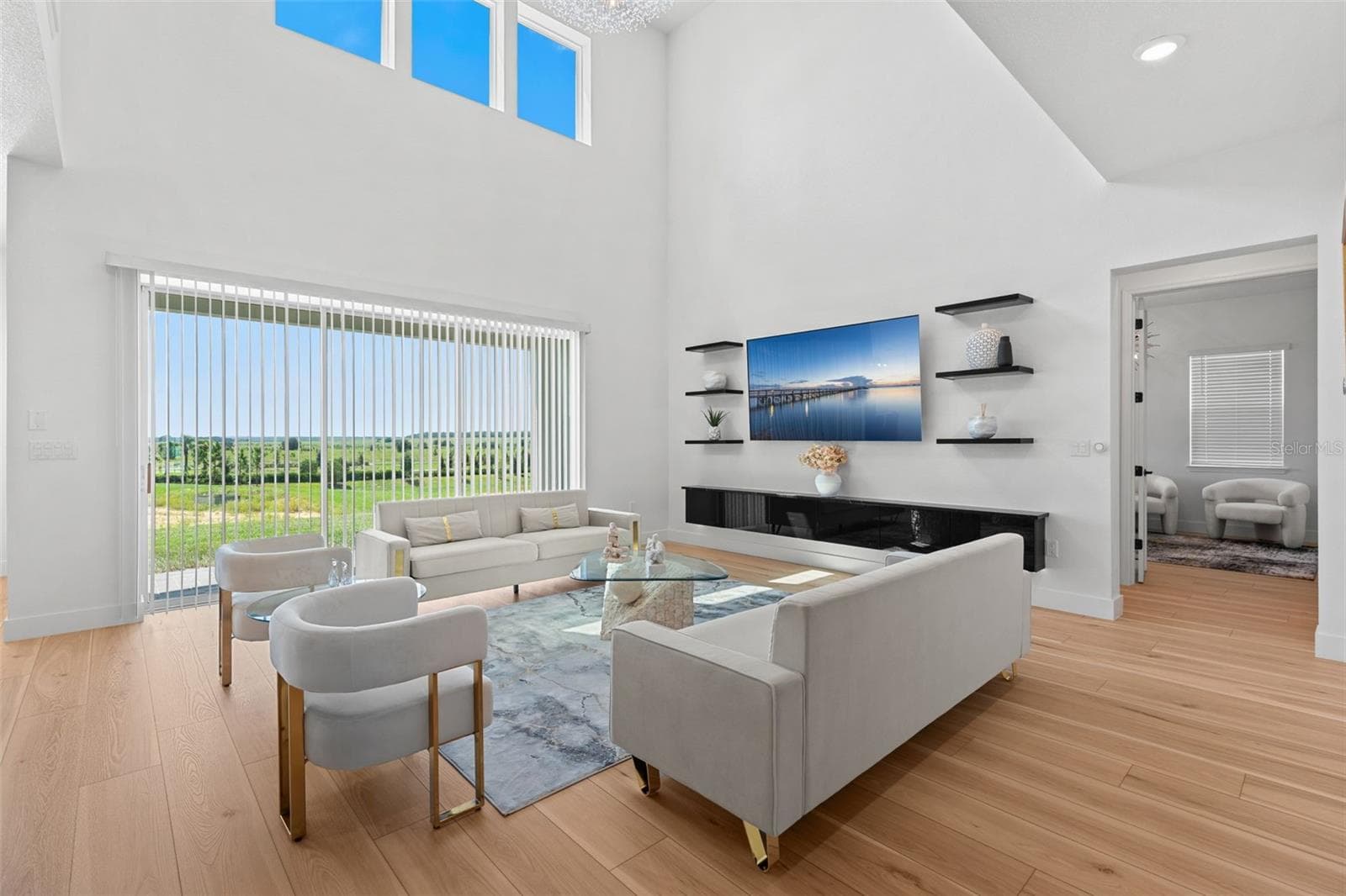 A wall of sliding glass doors let the natural light pour in. - 4617 GOLDEN BIRCH AVE, CLERMONT