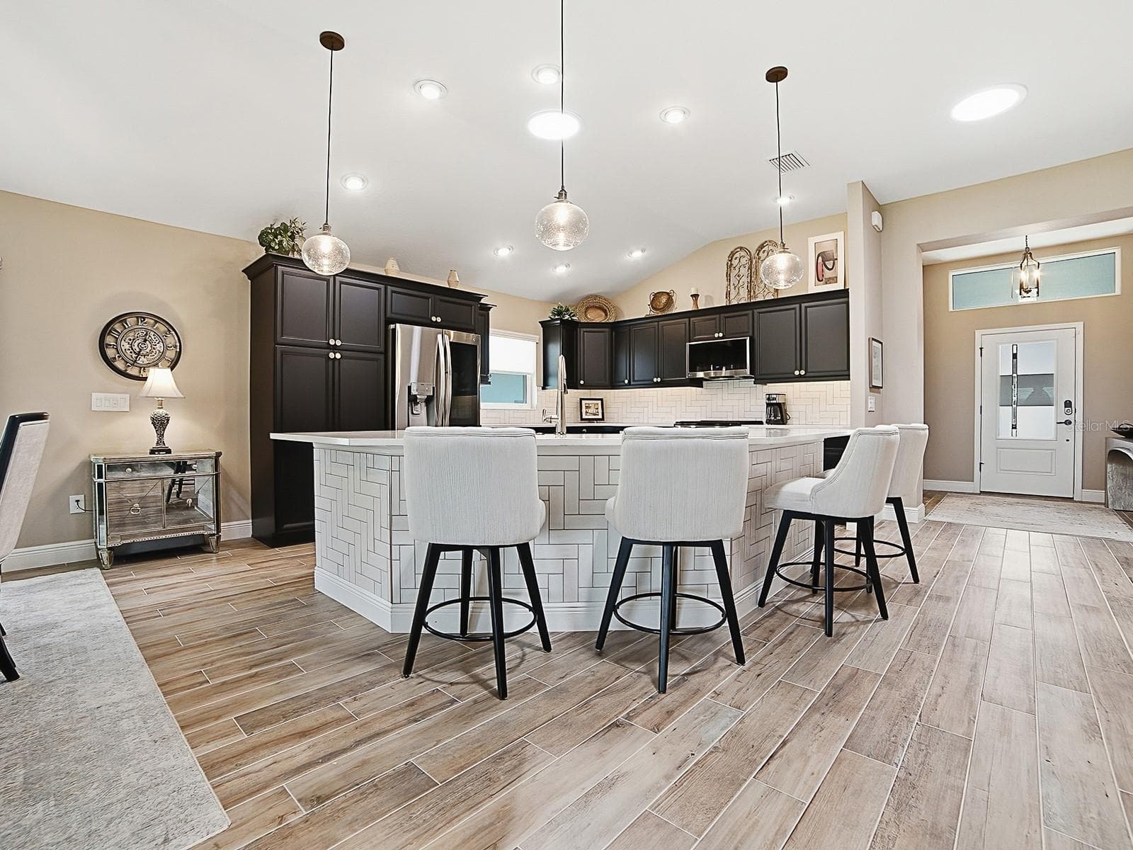 THE FRONT OF THE BREAKFAST BAR IS FINISHED OFF NICELY WITH THE SAME TILE AS THE BACKSPLASH. - 3075 LICCIARDELLO PATH, THE VILLAGES