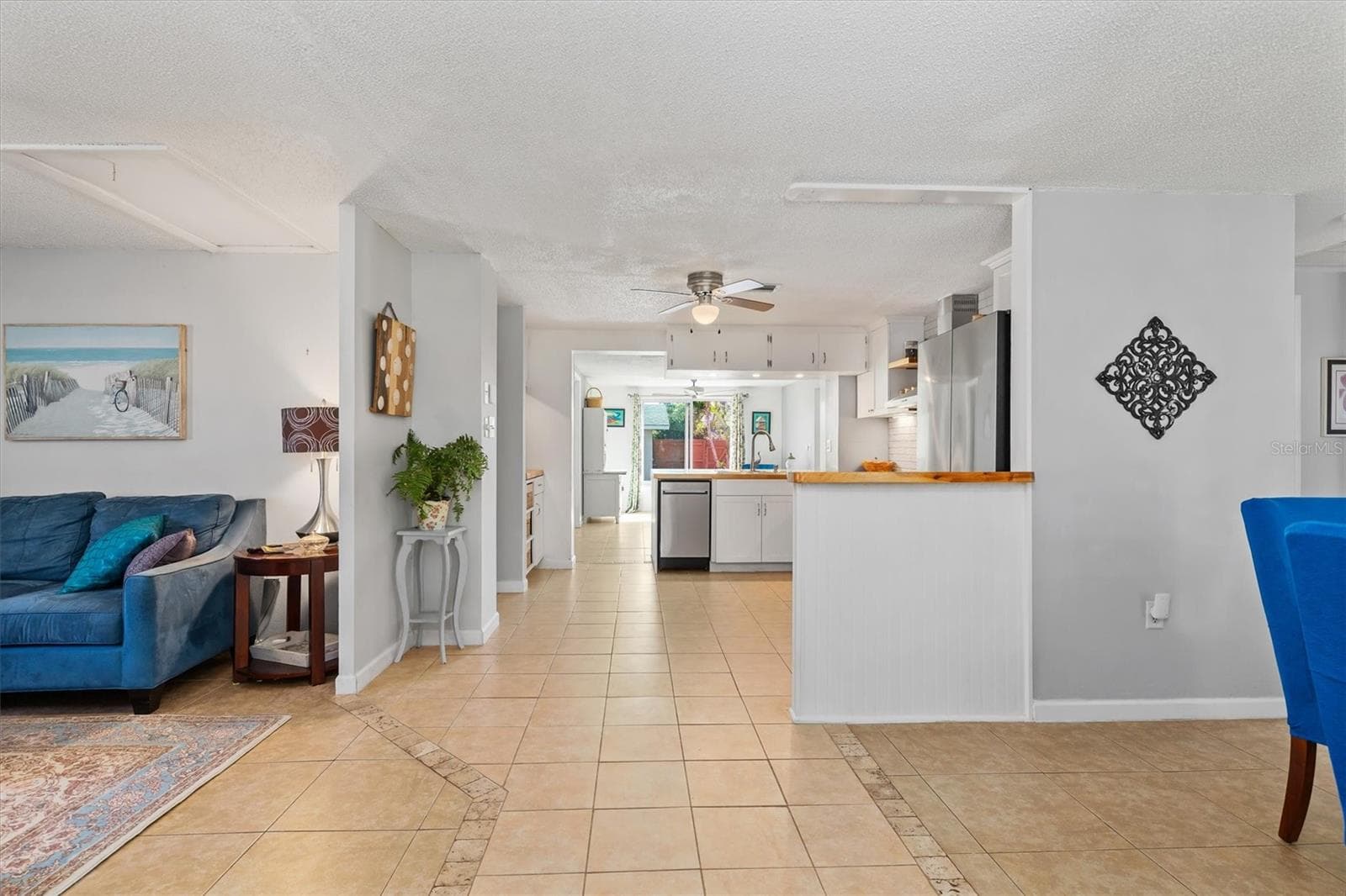 The open floor plan creates an easy connection from the front living areas through the kitchen and toward the rear of the home. Photo taken during prior occupancy. - 142 2ND AVE, NOKOMIS