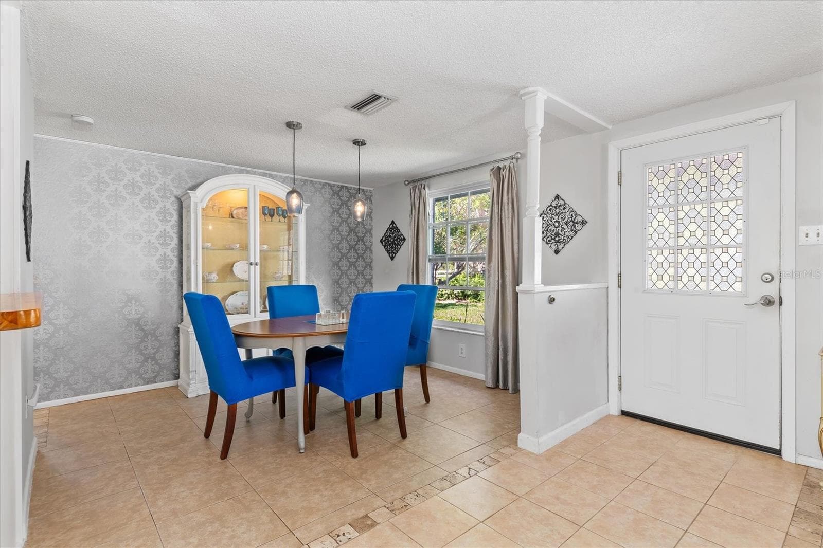 The dining area easily accommodates a full size table while remaining open to the main living spaces. Photo taken during prior occupancy. - 142 2ND AVE, NOKOMIS