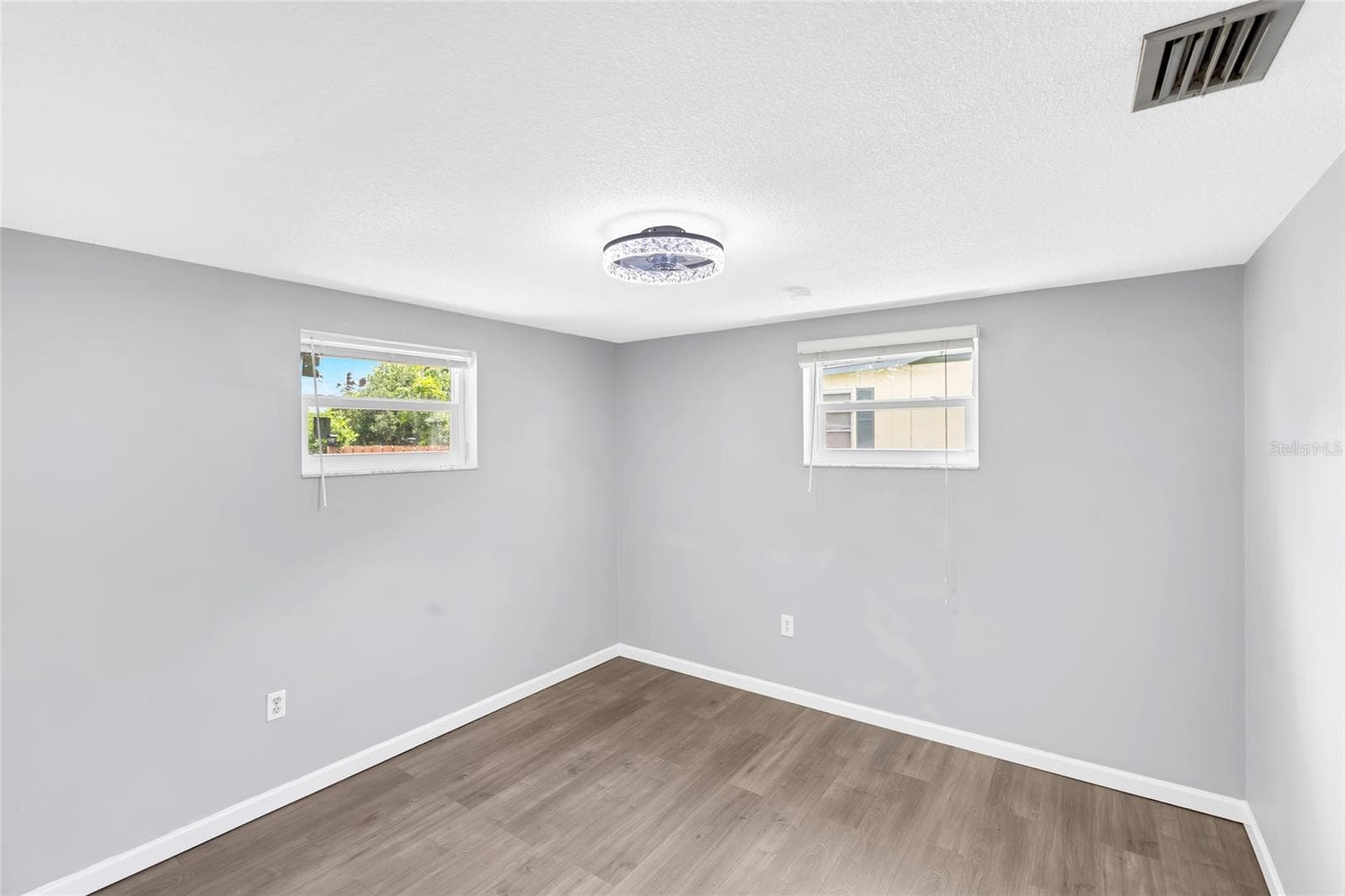 Bedroom 3 is bright and nicely sized, with two windows bringing in natural light and giving the room an open, airy feel. - 142 2ND AVE, NOKOMIS