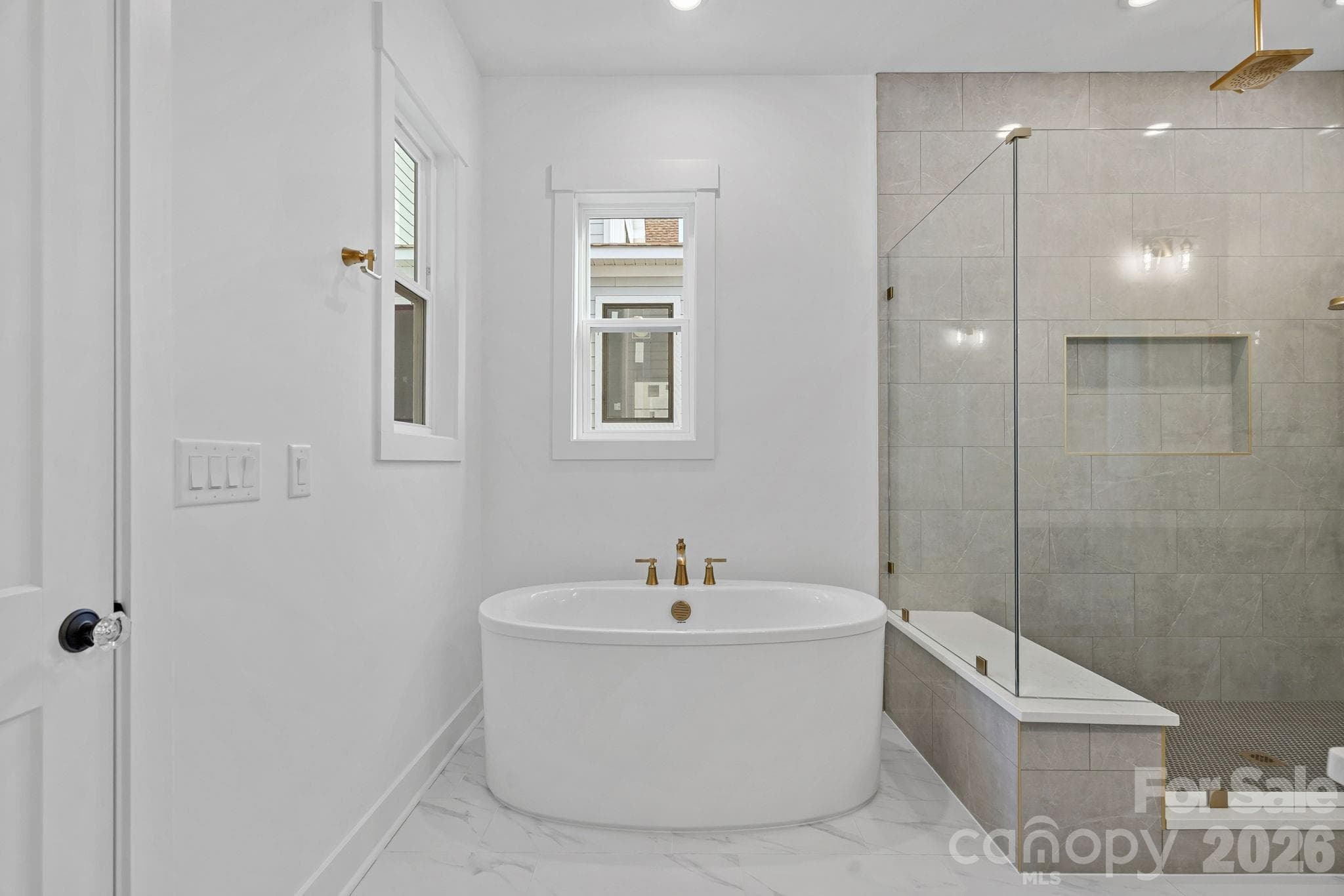 Primary ensuite with soaking tub, walk-in shower with rainshower heads and handled; large walk-in closet with built-ins. - 4477 Splash Trail, Sherrills Ford