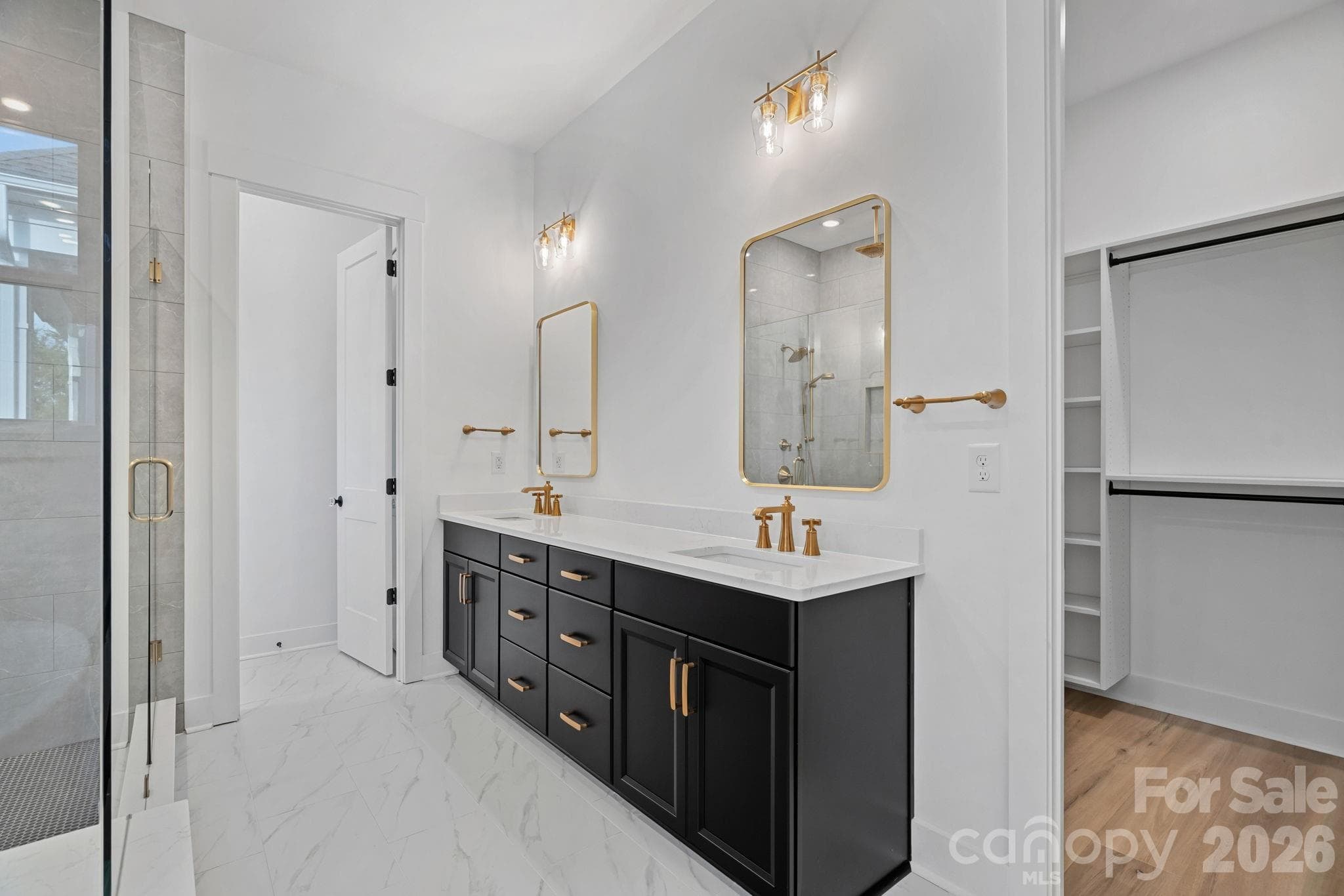 Primary ensuite with soaking tub, walk-in shower with rainshower heads and handled; large walk-in closet with built-ins. - 4477 Splash Trail, Sherrills Ford