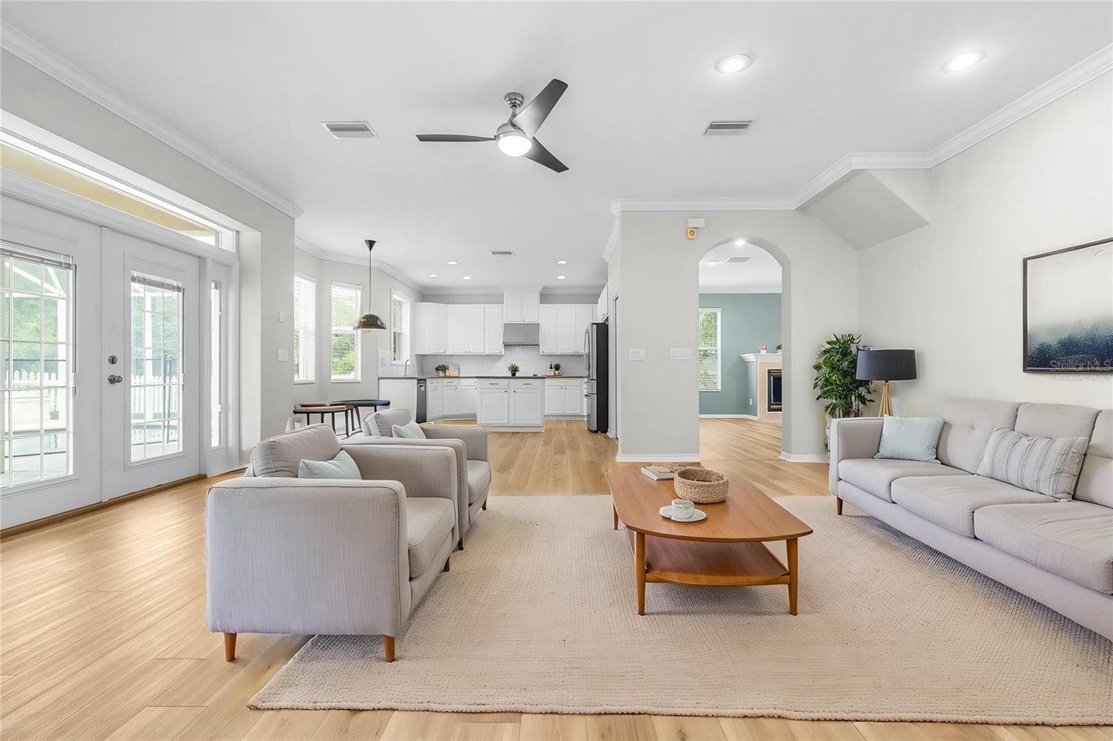 Virtually staged family room with adjoining eat-in kitchen - 27015 FIREBUSH DR, WESLEY CHAPEL