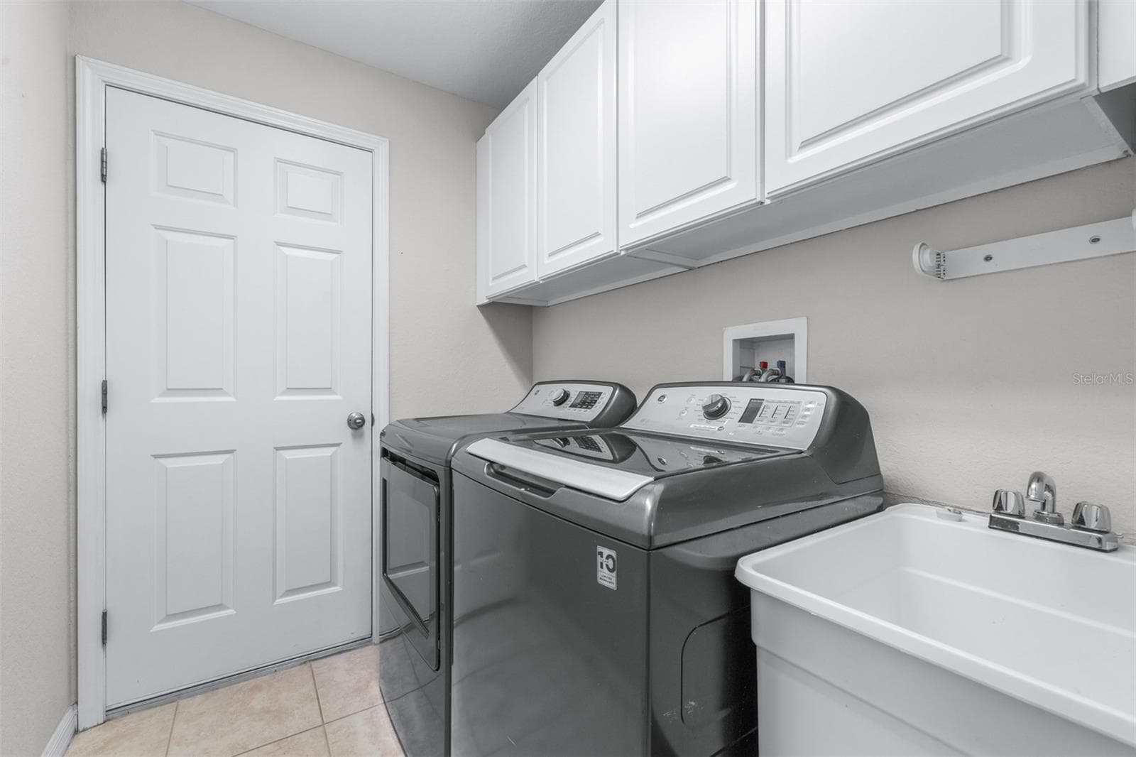 Laundry room with garage entrance - 27015 FIREBUSH DR, WESLEY CHAPEL