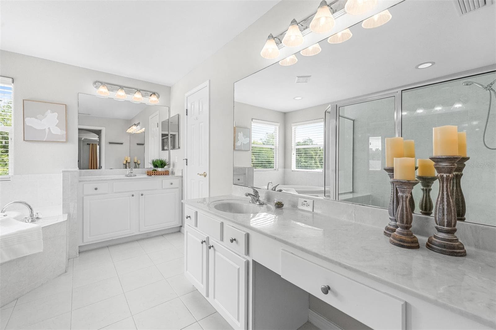 Primary bathroom with dual vanities, large shower and garden tub. - 27015 FIREBUSH DR, WESLEY CHAPEL