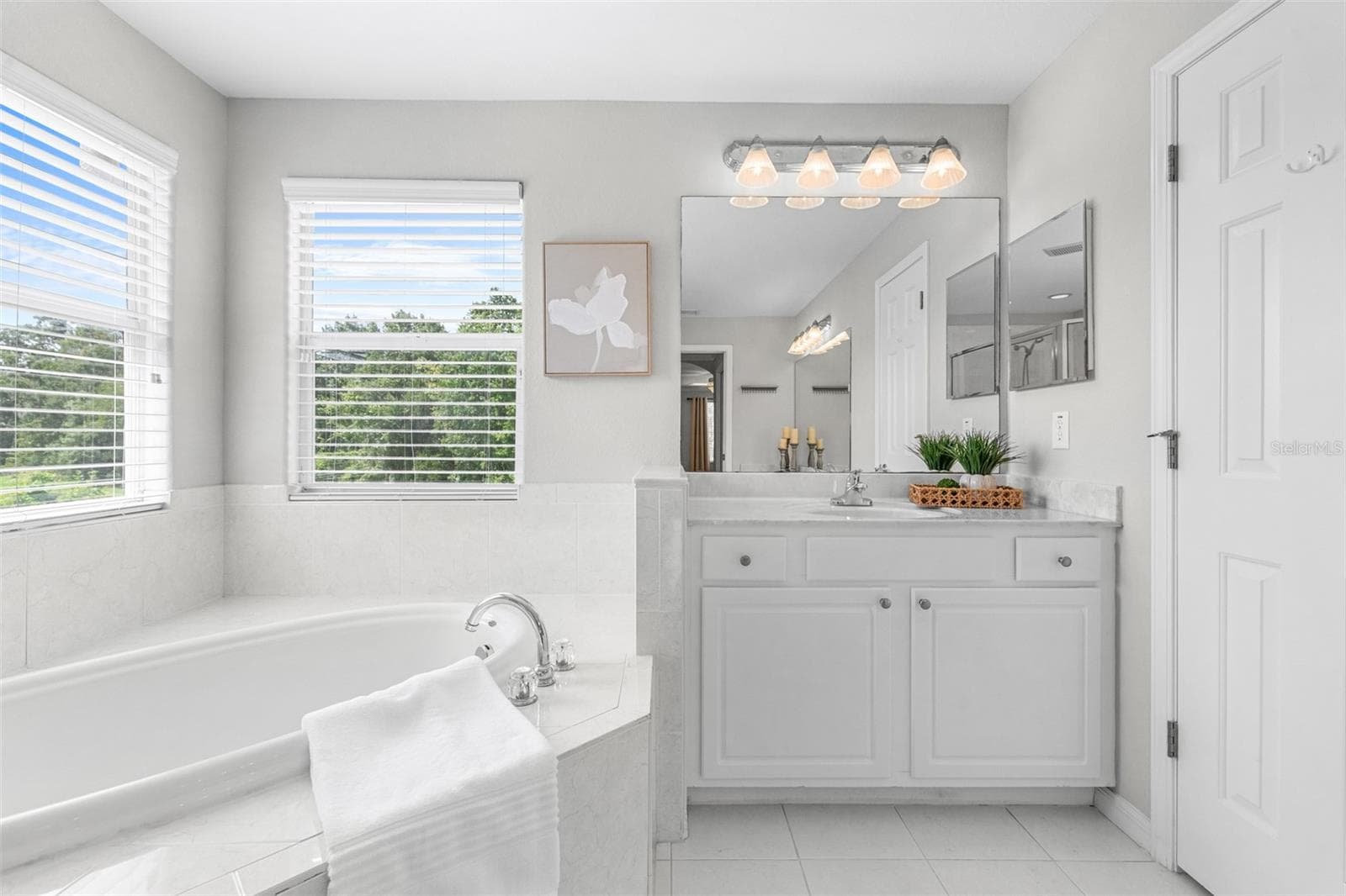 Primary bathroom with dual vanities, large shower and garden tub. - 27015 FIREBUSH DR, WESLEY CHAPEL