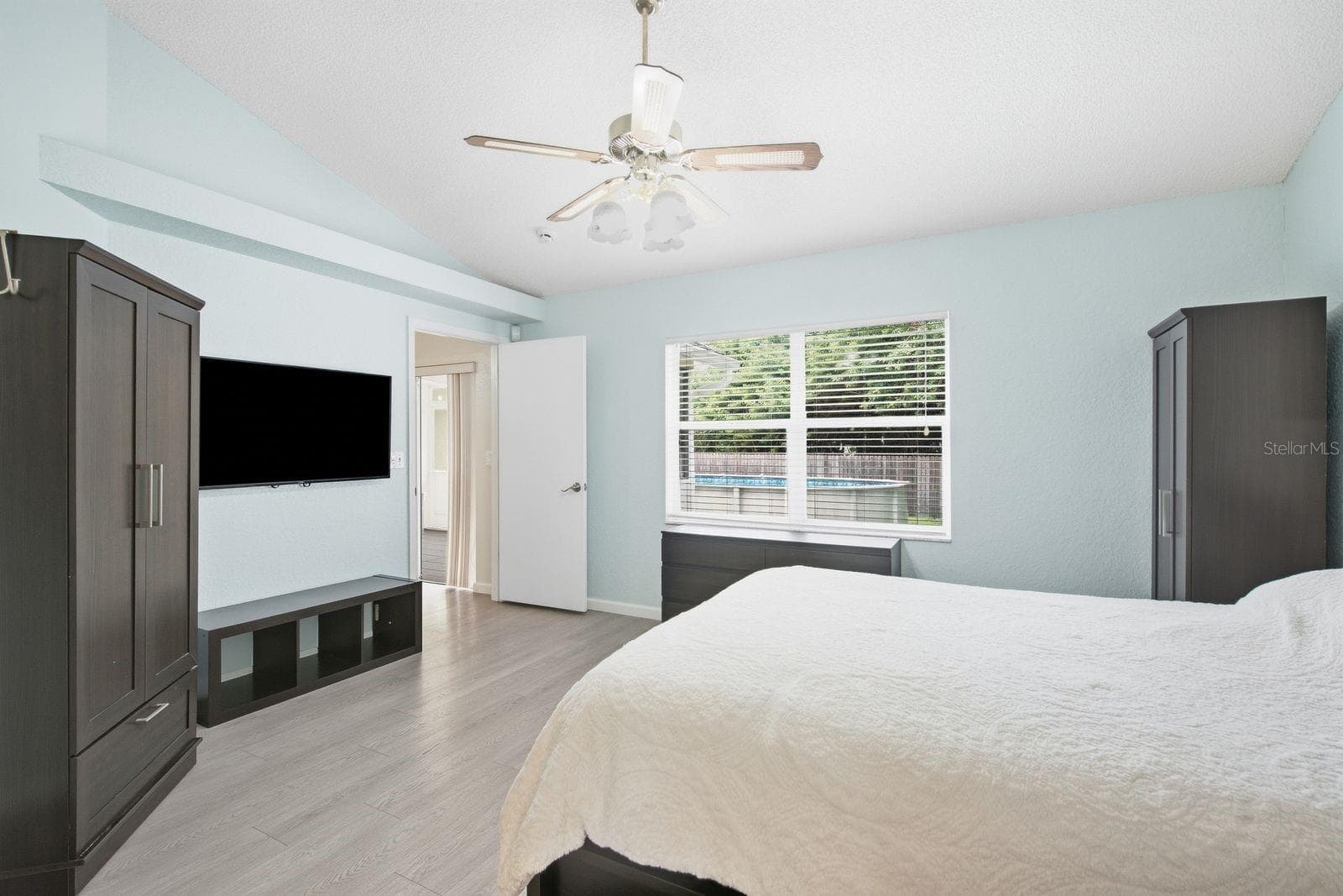 Primary bedroom with walk in closet, en suite bathroom and overlooking beautiful backyard. - 5955 107TH TER N, PINELLAS PARK