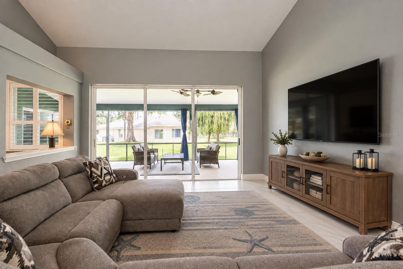 Virtually removed items from the lanai and great room and virtually added TV with cabinet. - 4465 FAIRWAY OAKS DR, MULBERRY