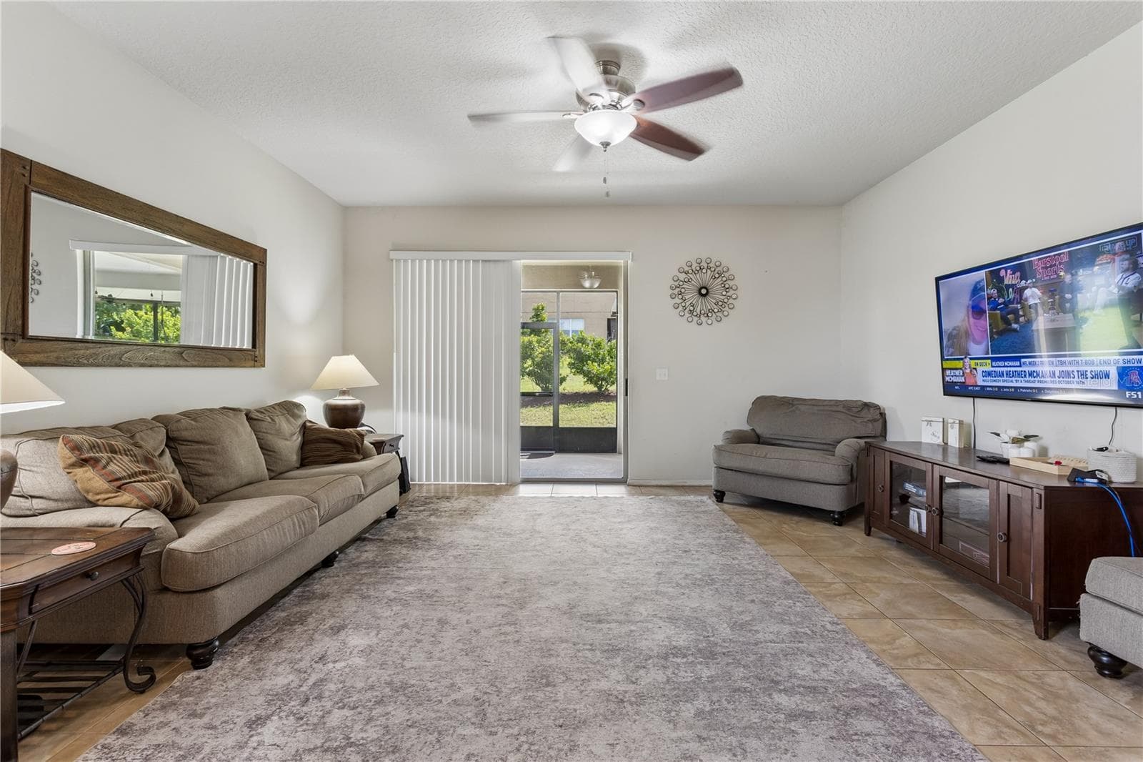 Spacious family room with doors leading out to the covered lanai and patio. - 30022 DONNINGTON LOOP, MOUNT DORA