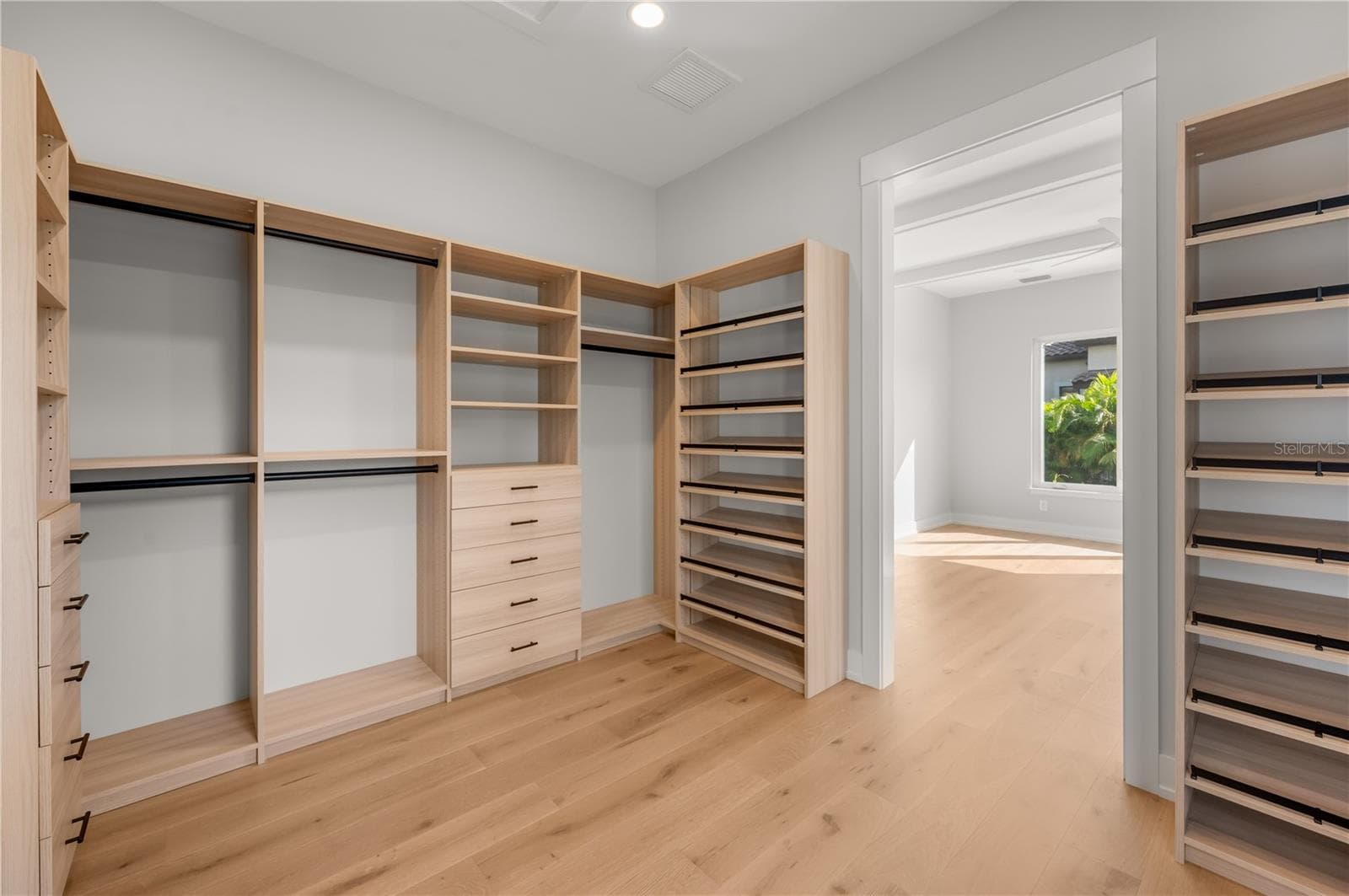 Primary bedroom walk in closet with built in closet system. - 3360 BAYOU SOUND, LONGBOAT KEY